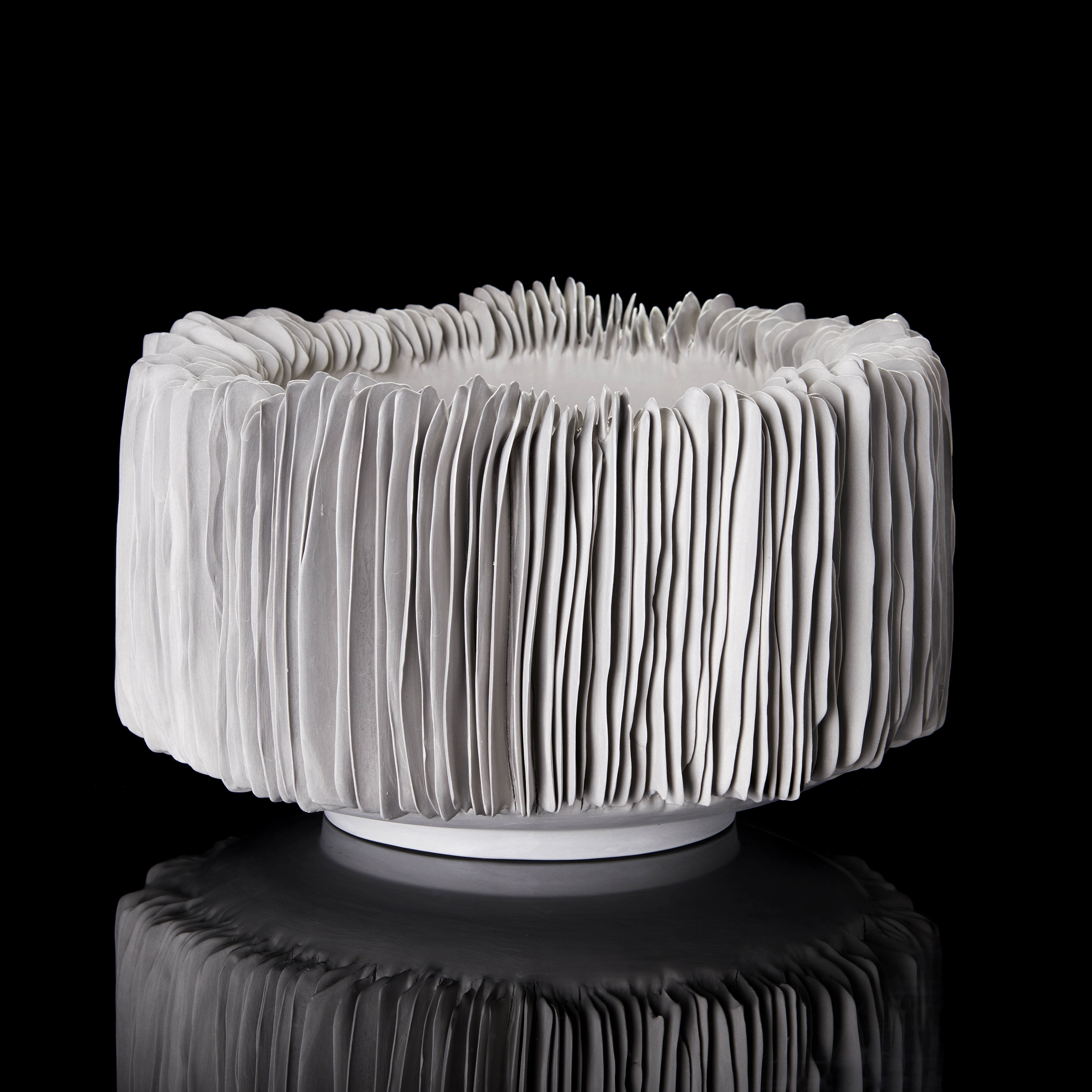 grey round straight sided handmade porcelain footed bowl with ridged covered exterior