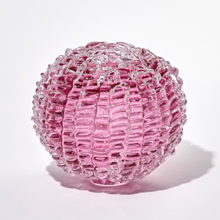 pink ridged globe shaped sculpture handmade and sculpted from glass with small top opening