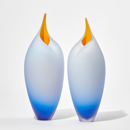 blue tall birds with rounded forms and open beaks and yellow mouths