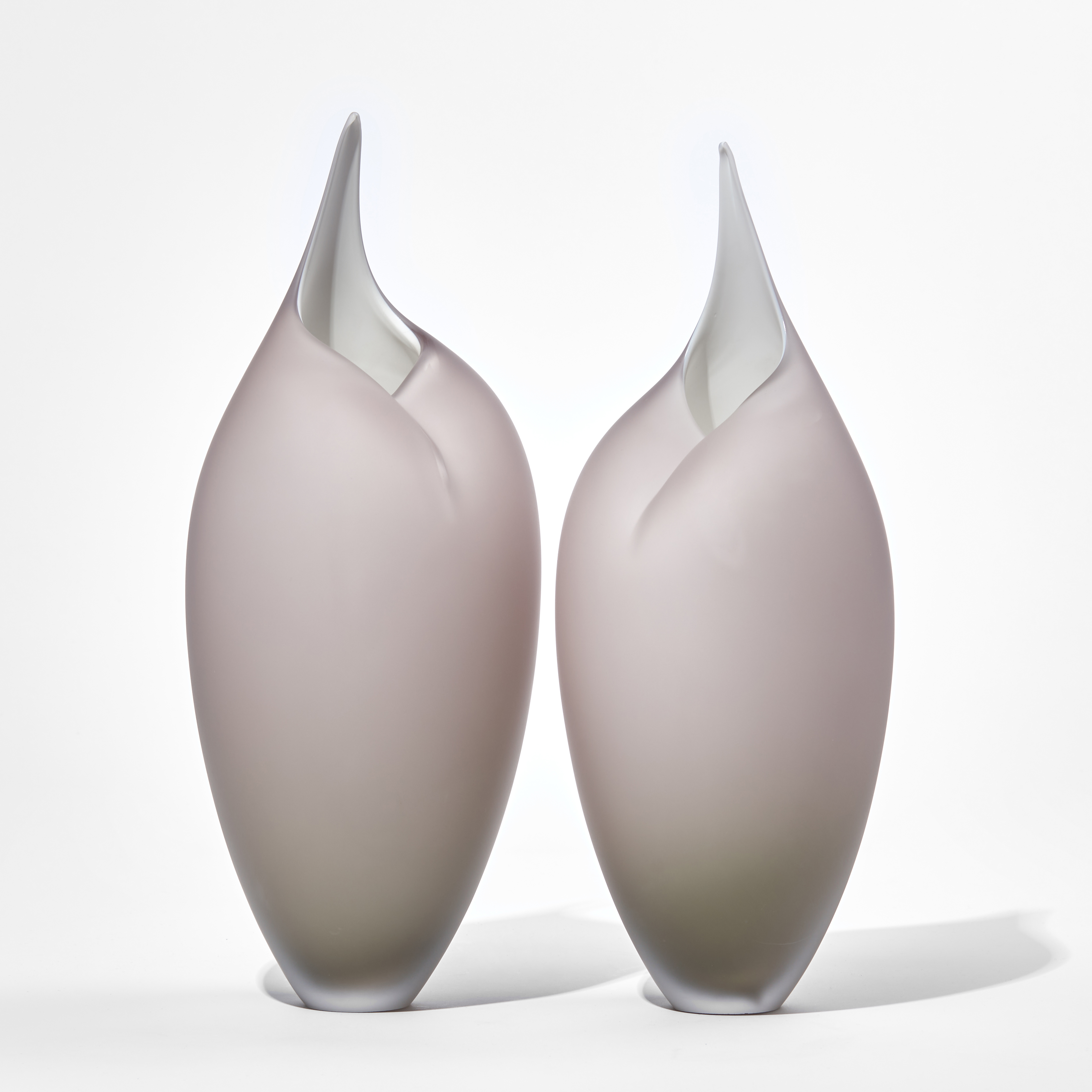 two modern art glass sculptures in bird like shape in white and light grey