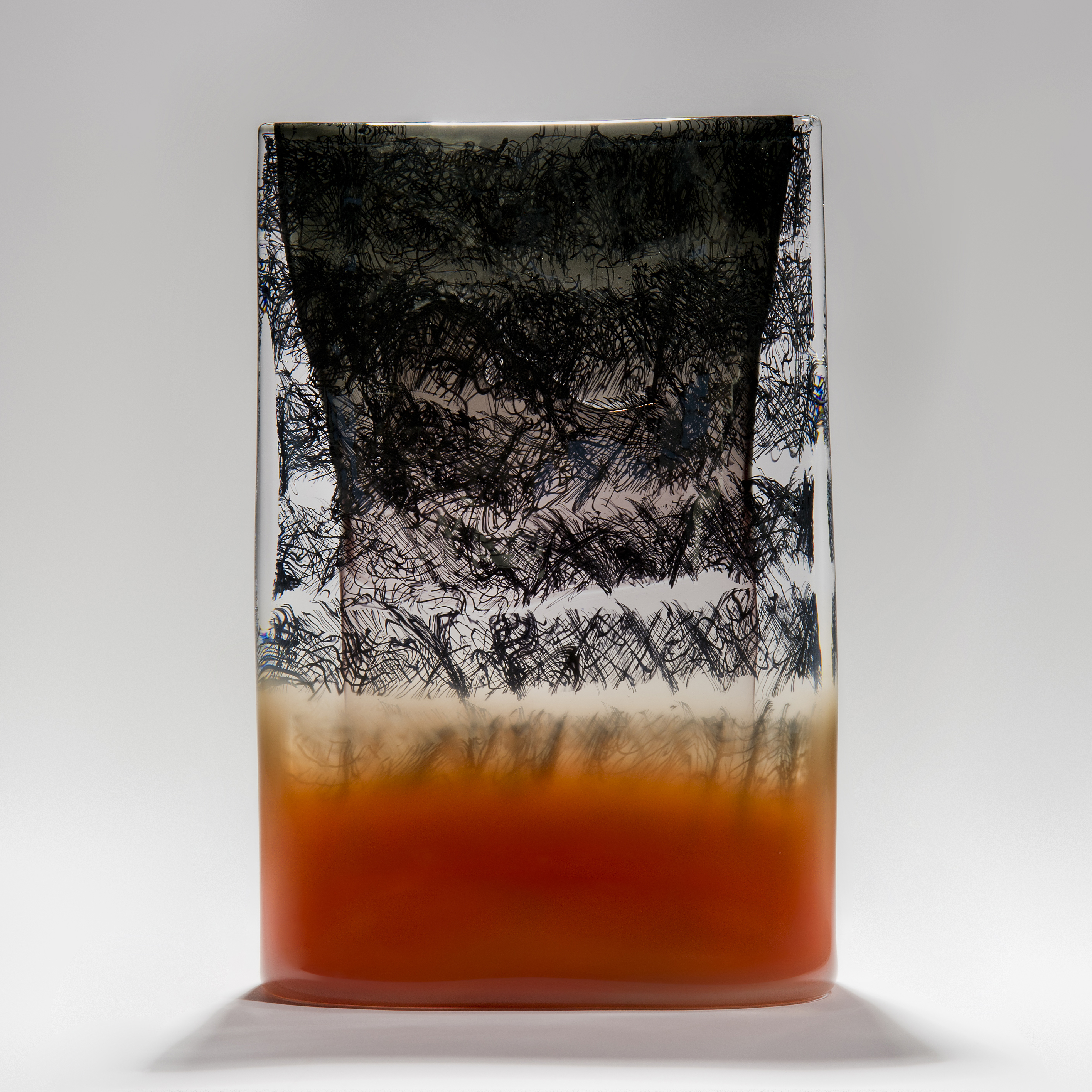 black grey clear and red rectangular block sculpture handmade from glass with small black line repeated detail