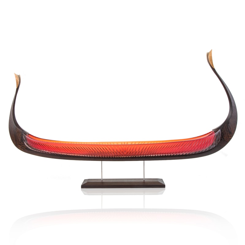 handblown glass and carved wood sculpture of viking ship in red and dark brown