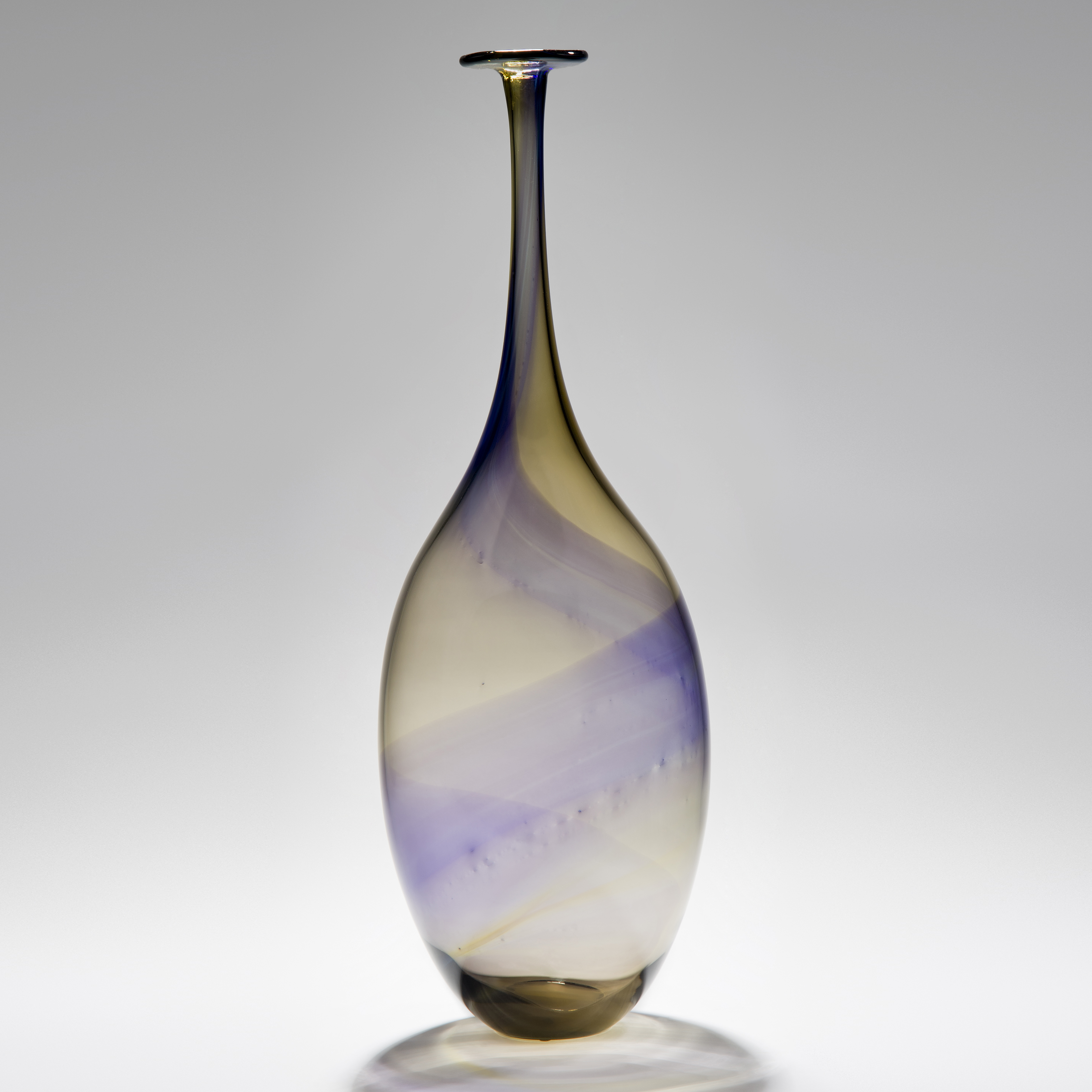 purple and amber swirling stripes of colour around a long necked bottle handmade from glass
