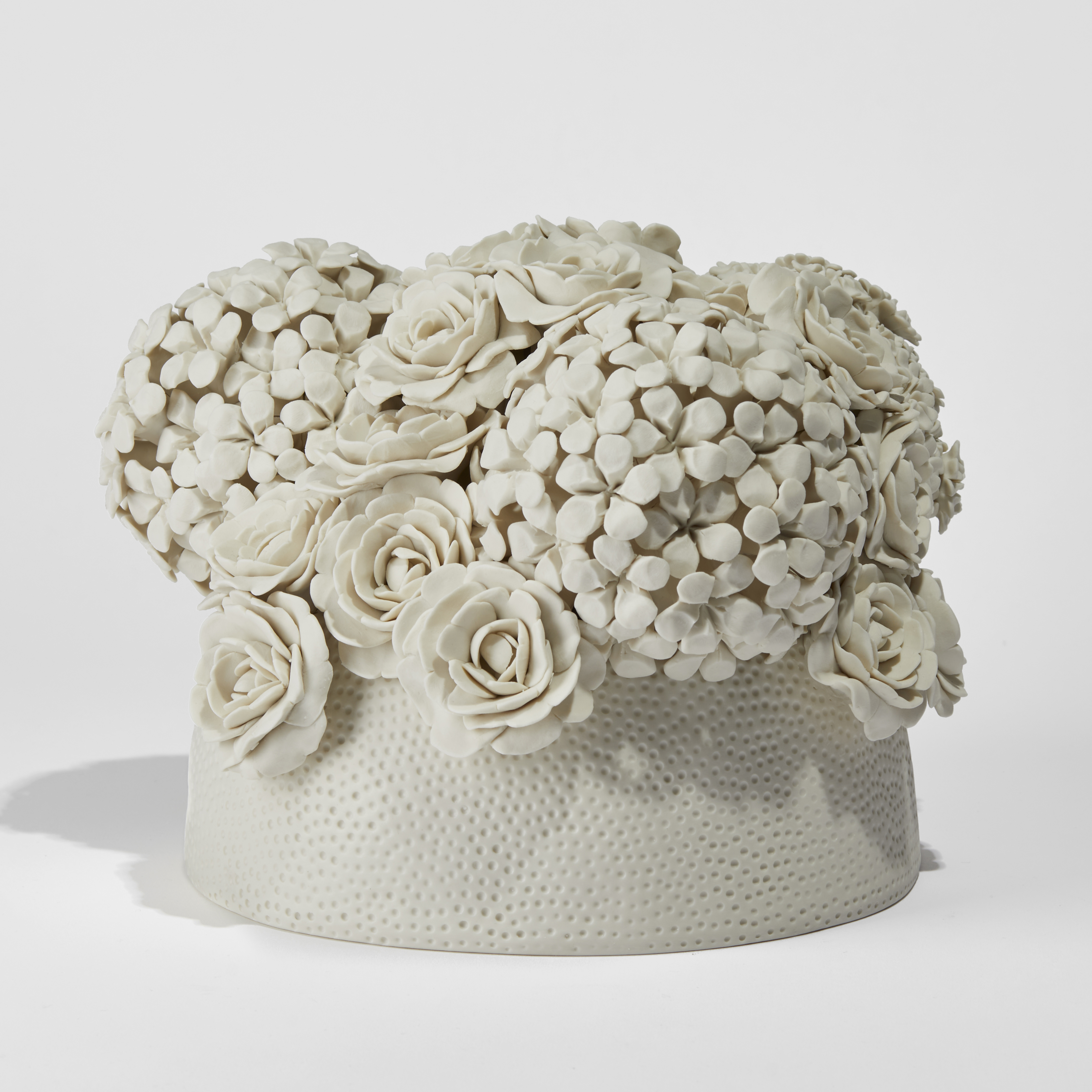 cream floral centrepiece with circular dotted base hand made from porcelain