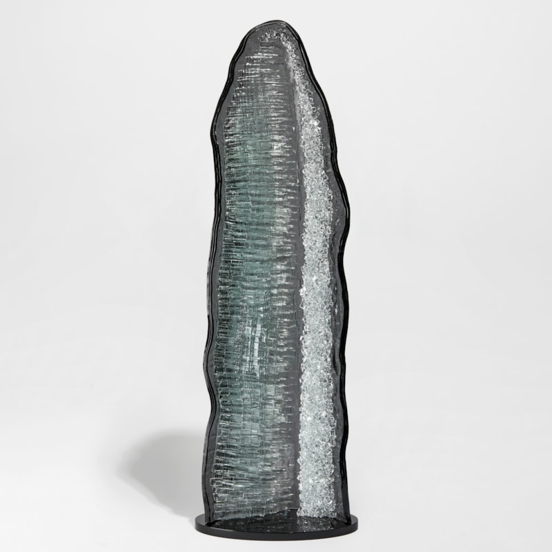 monolithic rock like handmade sculpture in  black grey and clear glass with crystal interior detail
