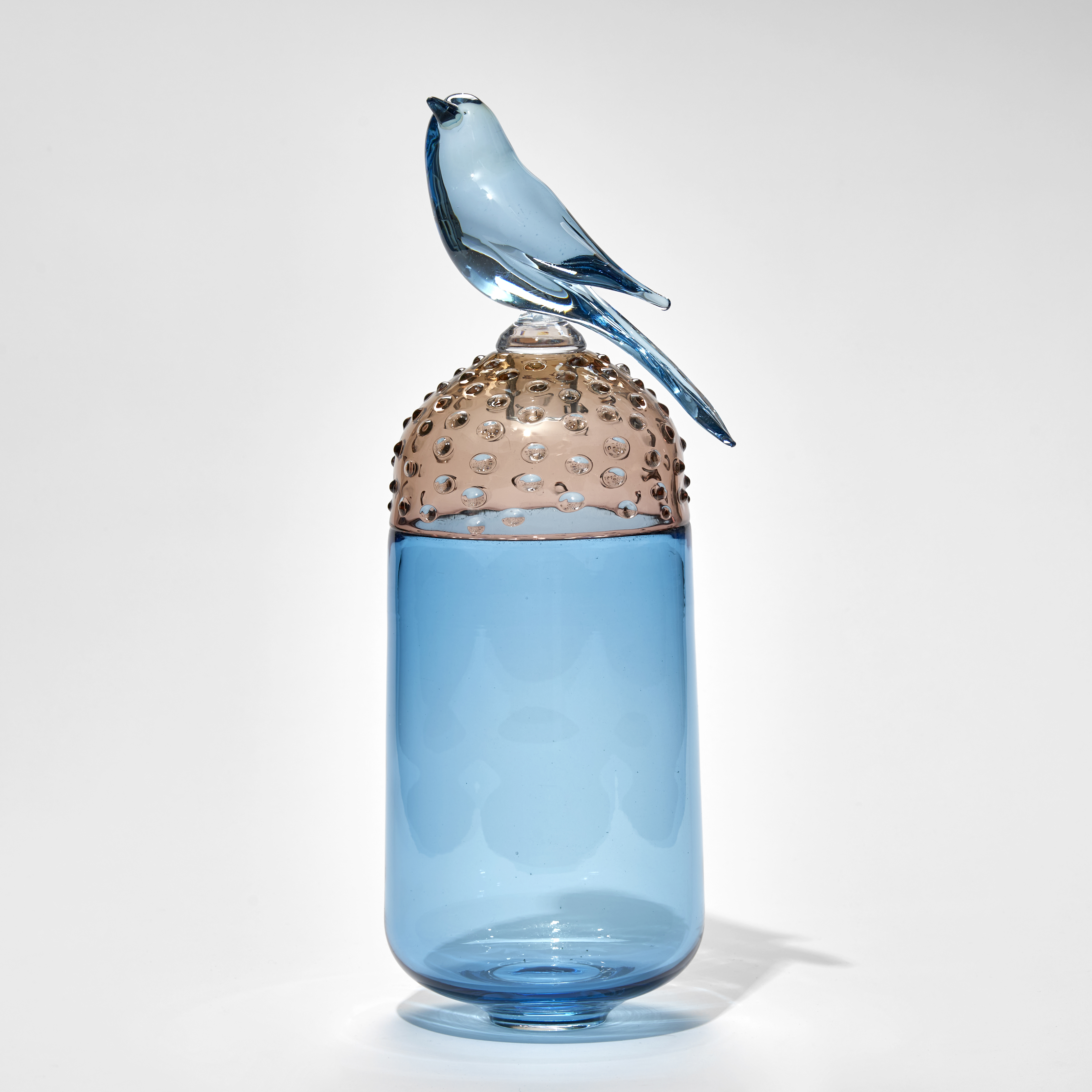 blue and soft bronze tall spotty domed lidded jar with blue bird on the top hand made from glass
