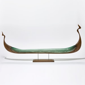 wood and glass sculpture of viking ship in green and brown on wooden base