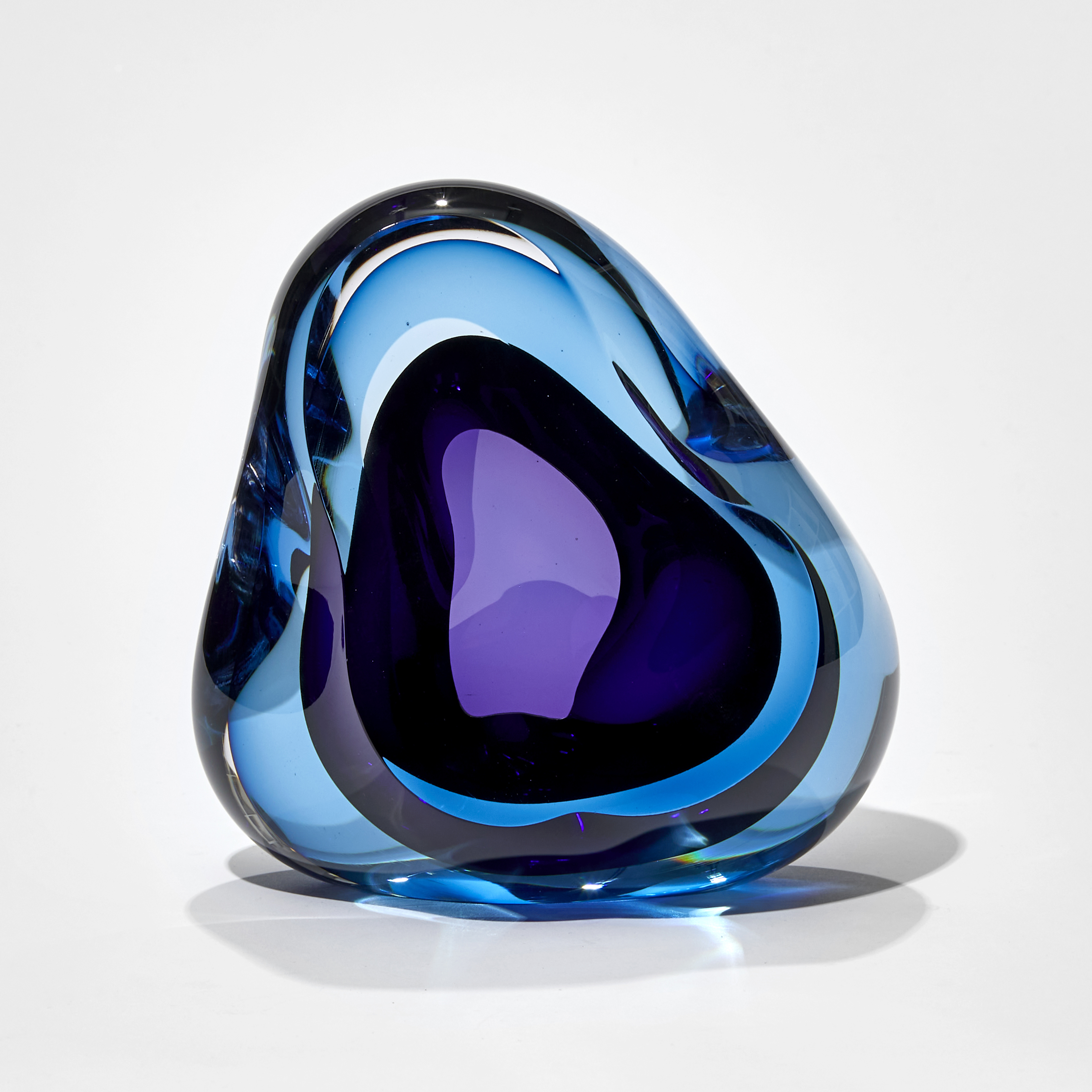 deep turquoise and purple amorphic sculpture hand crafted from glass with central opening