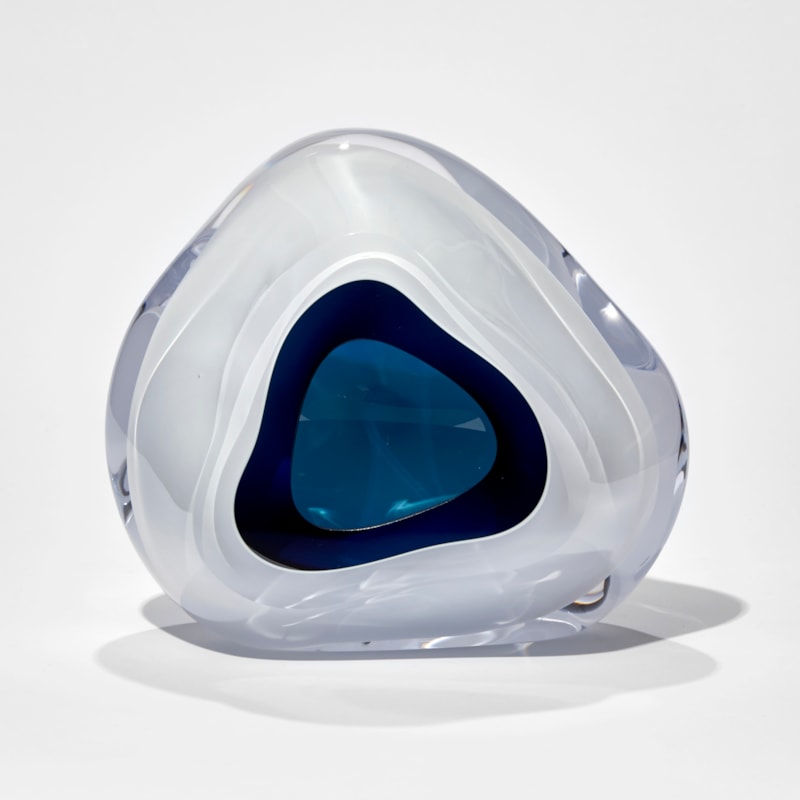 white and dark turquoise soft triangular sculpture with central aperture hand made from glass