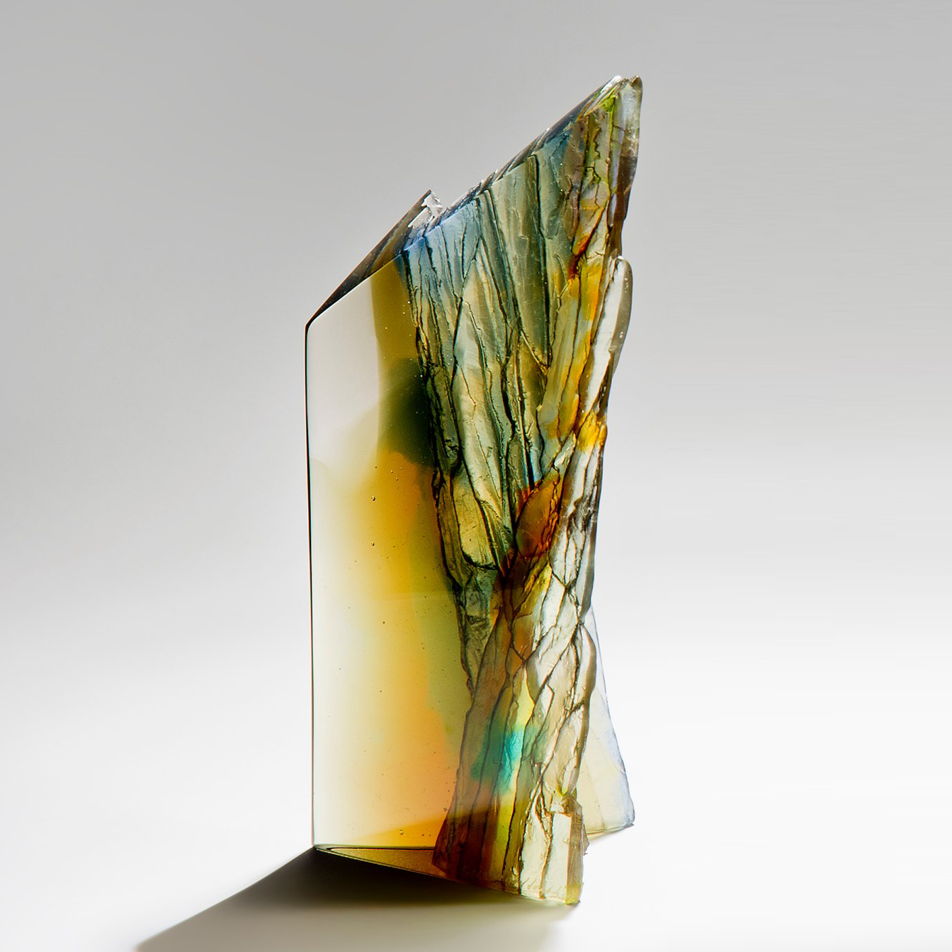 modern art glass centrepiece sculpture of cliffs in multicoloured autumnal shades