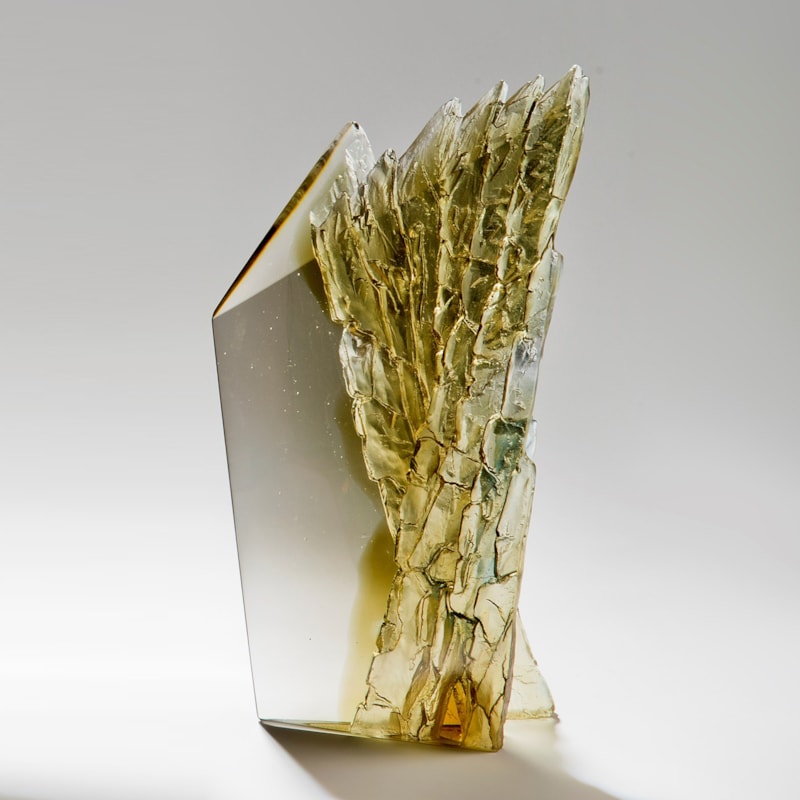 cast glass sculpture of rugged cliff edge in clear and dark colours