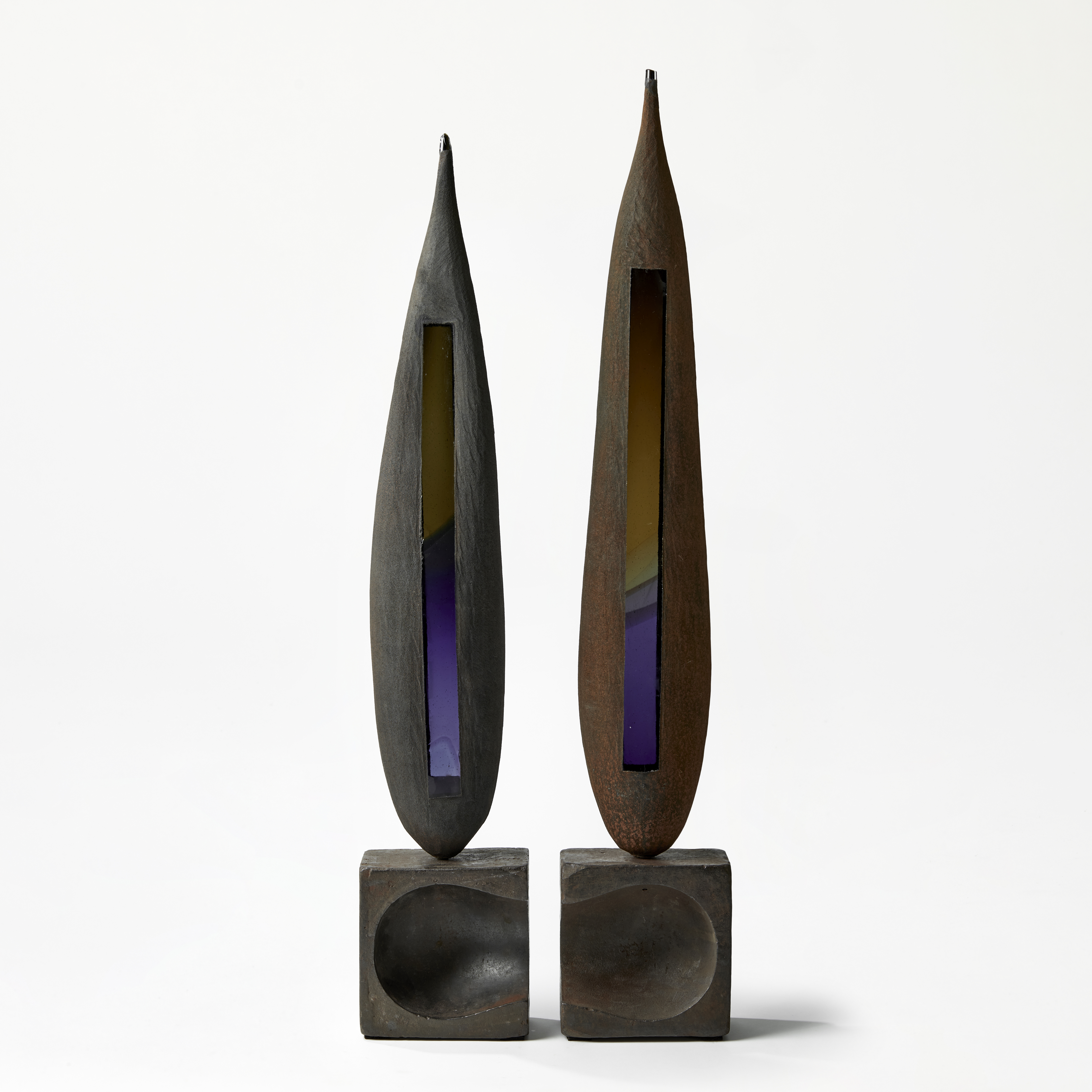 grey brown green and blue tall pointed aged looking twinned sculptures with weathered appearance handmade from blown glass and steel