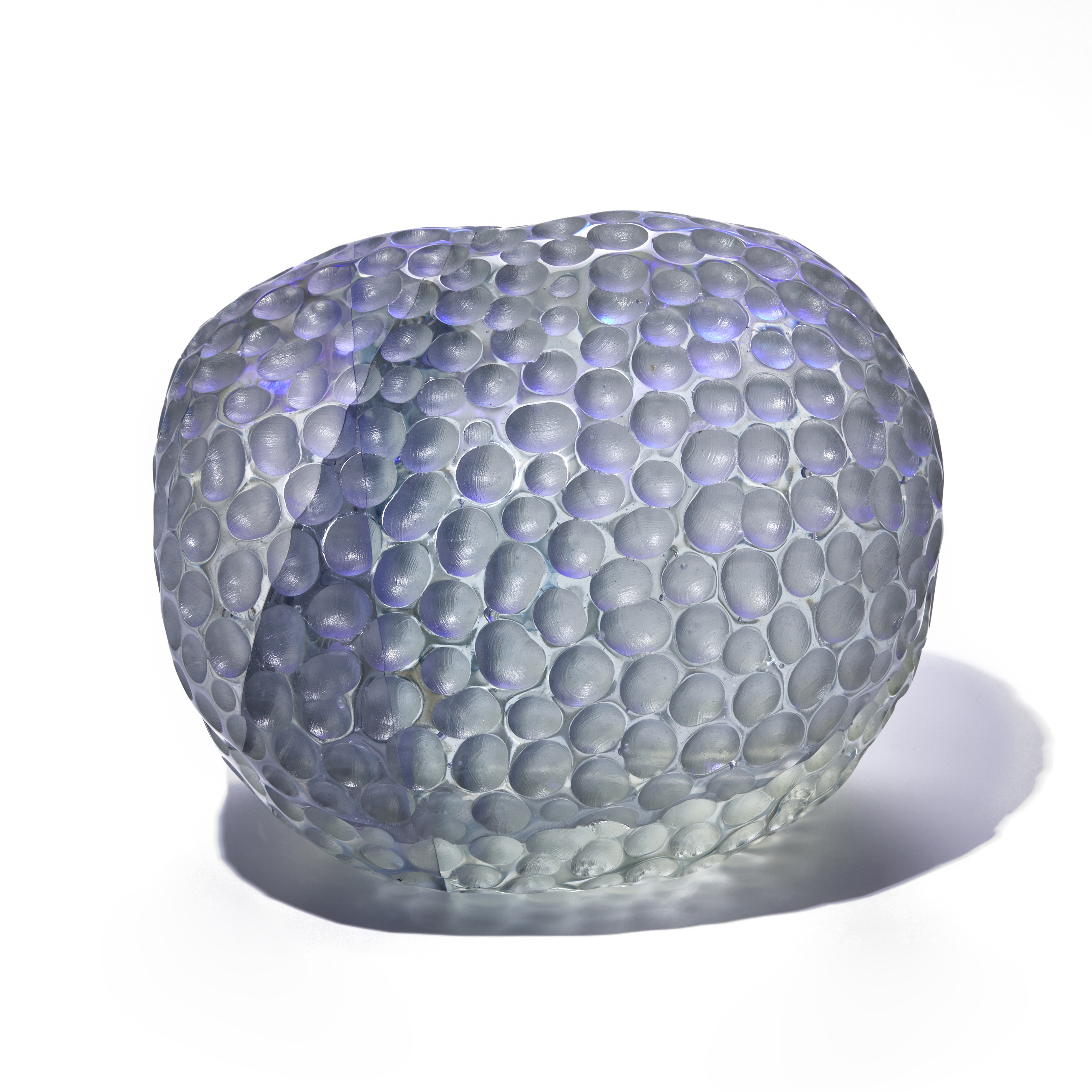 grey and purple depressed rounded sculpture with dimpled surface handmade from glass