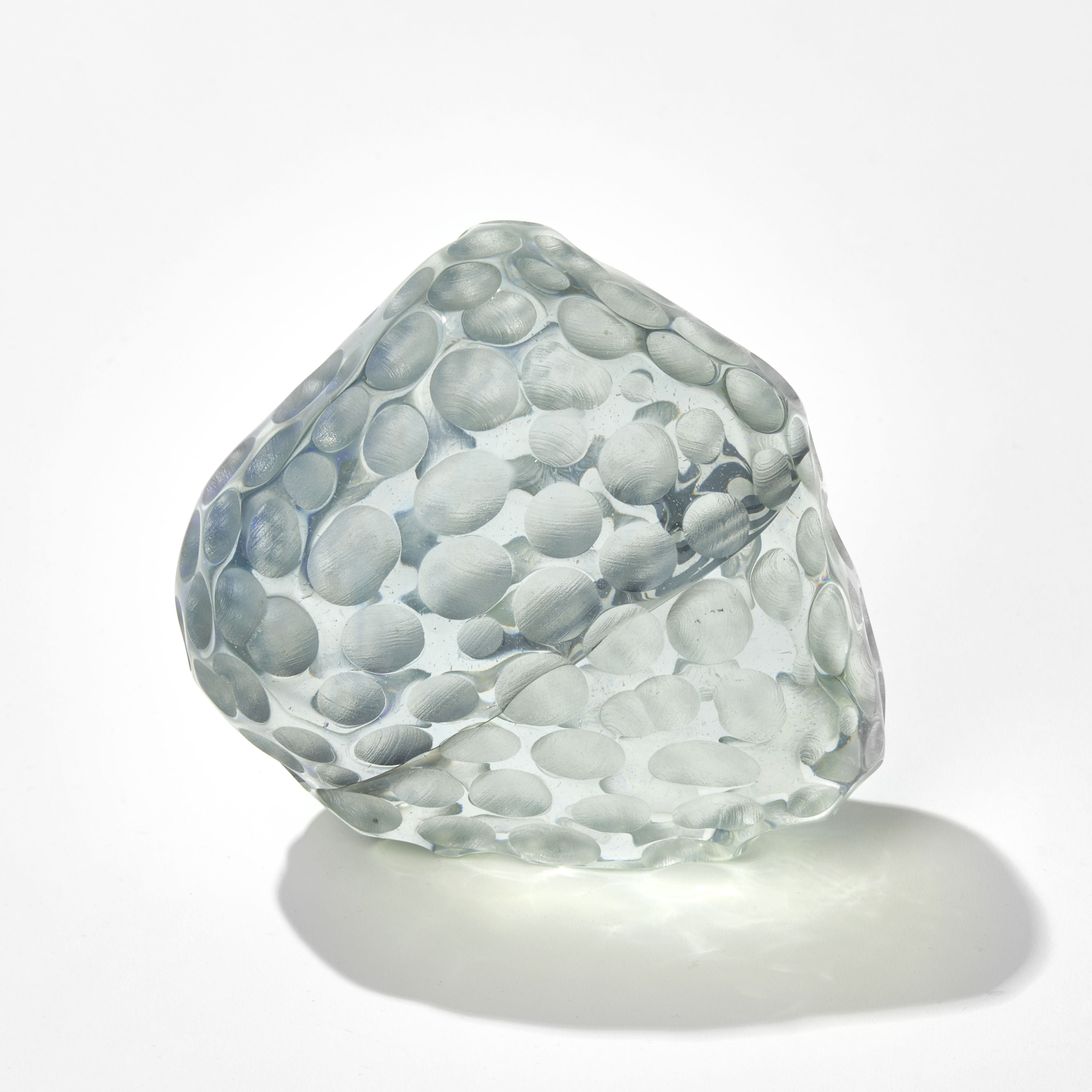 grey and purple rock like mass with dimpled surface hand made from glass