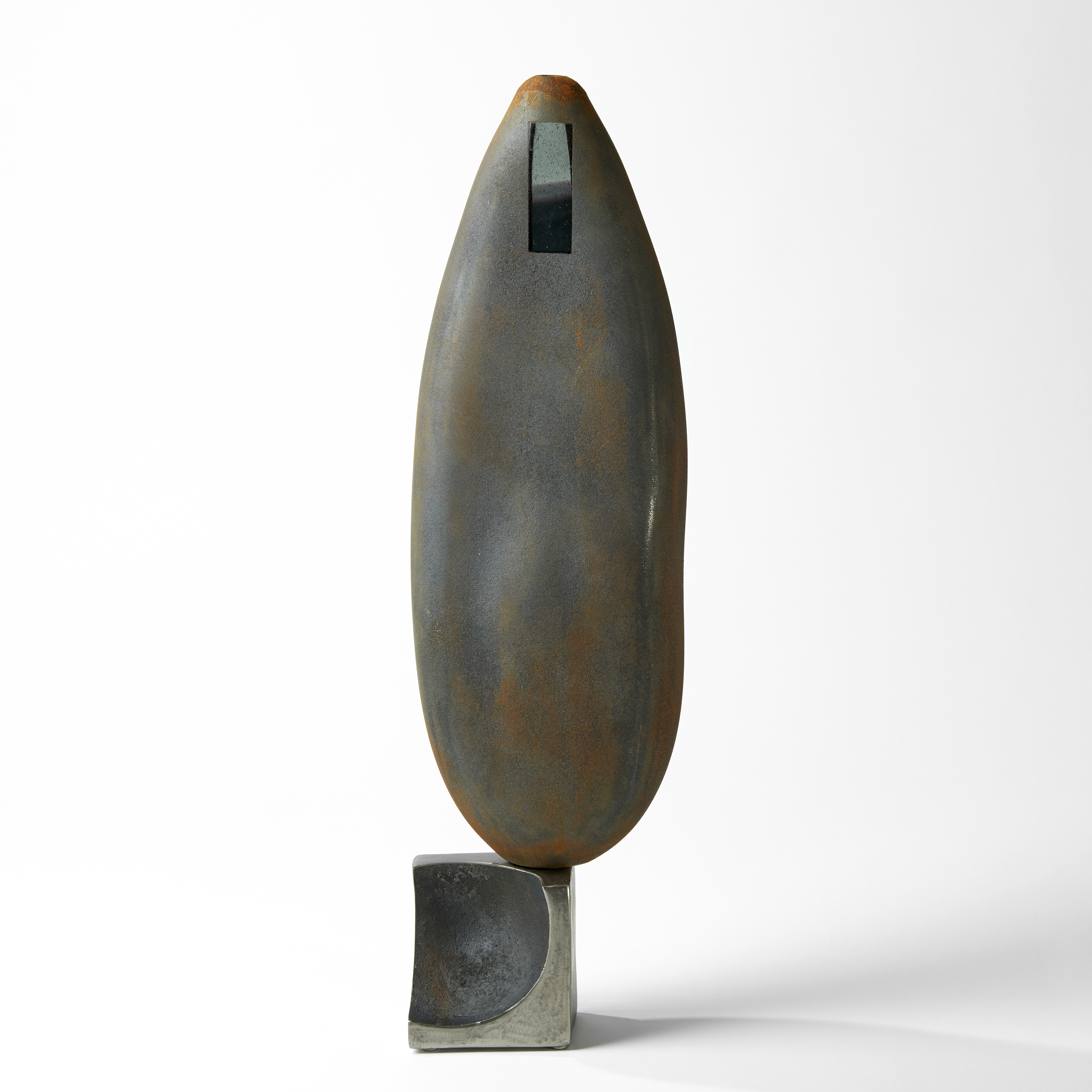 grey and rust tall ovoid sculpture with small window apertures and steel base handblown from glass
