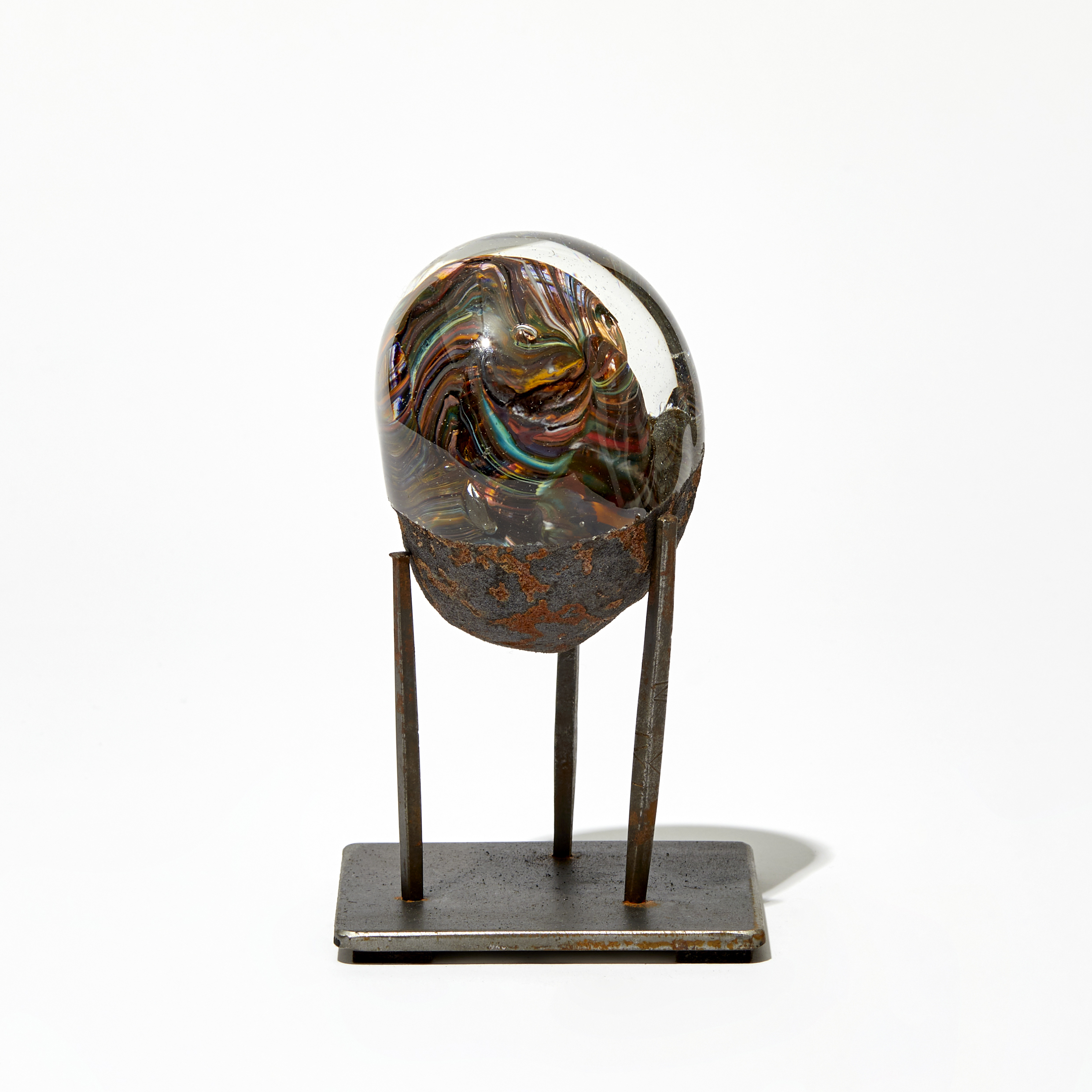 rust and clear egg shaped sculpture handmade from glass and steel