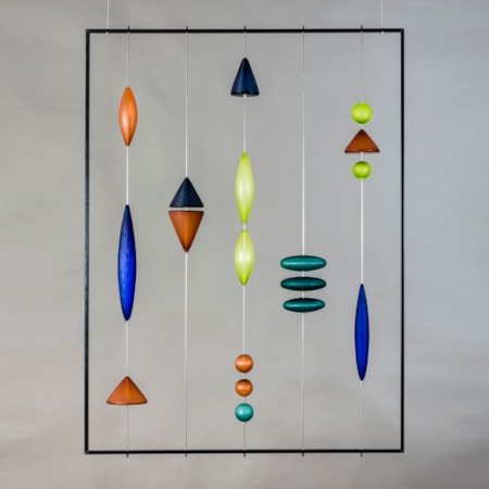 steel frame with suspended coloured handblown and cut geometric shapes in blue amber and jade