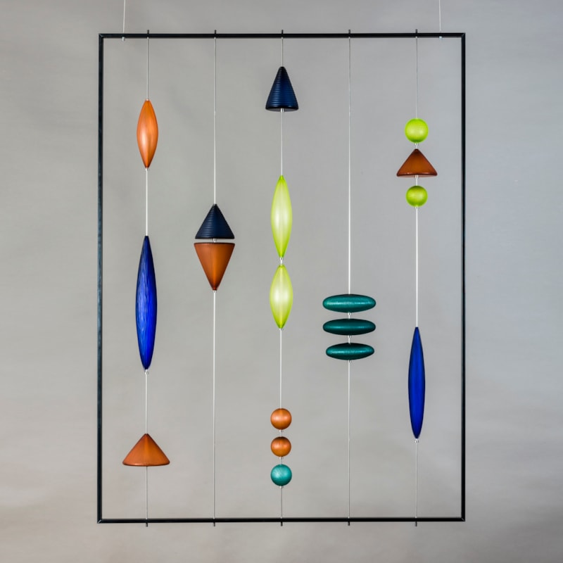 steel frame with suspended coloured handblown and cut geometric shapes in blue amber and jade