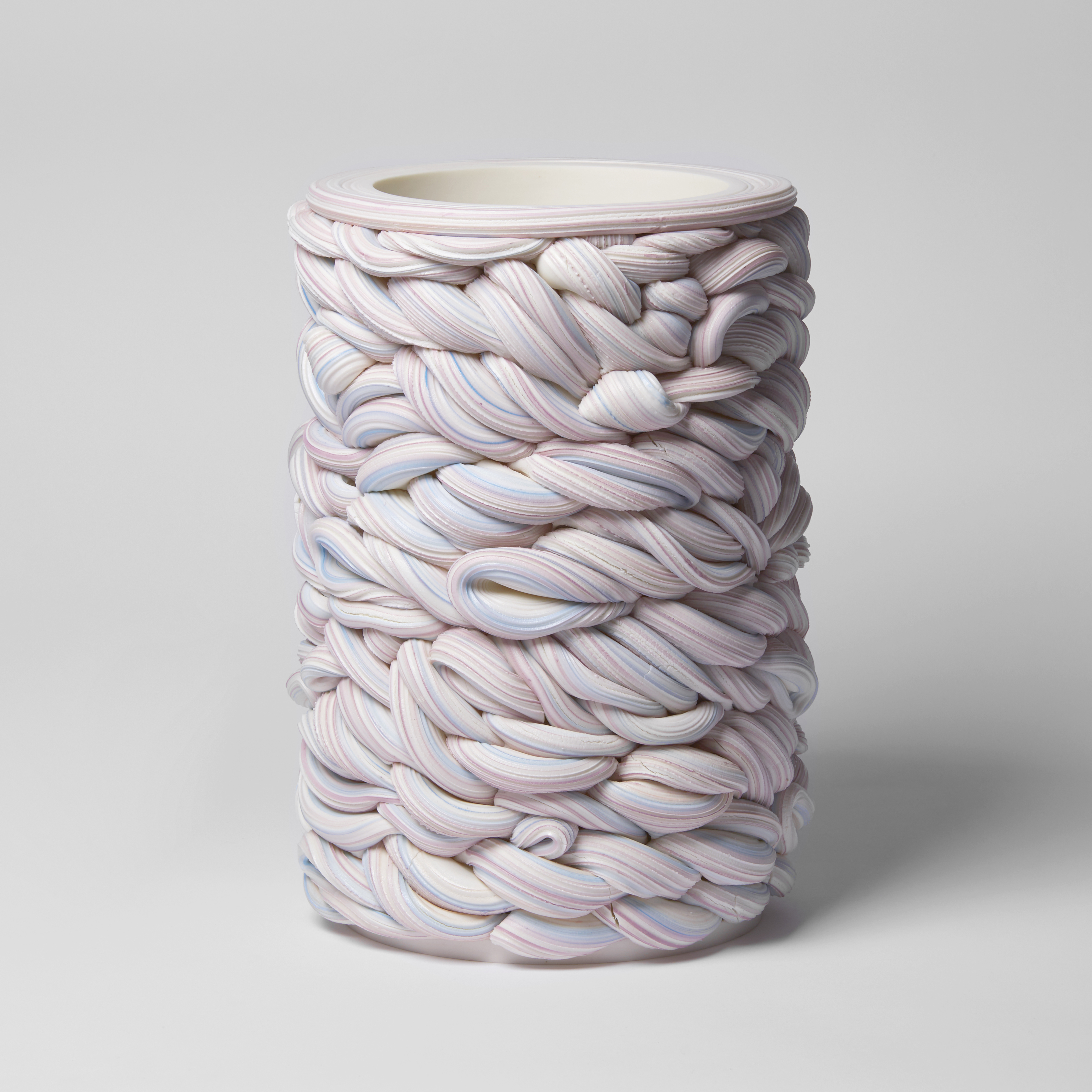 handmade cylindrical shaped vessel created from woven striped tubes of clay in white purple and blue