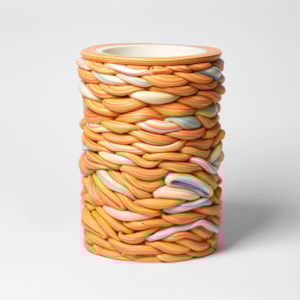 interwoven sticks of rock created a stacked circular vessel handmade from parian porcelain