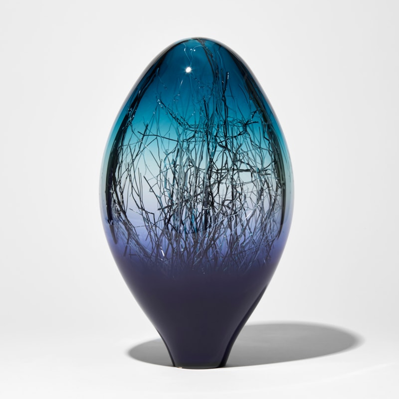 rich purplish blue and aqua coloured sculpture with interior fine dispersed black white and gold canes hand made from glass