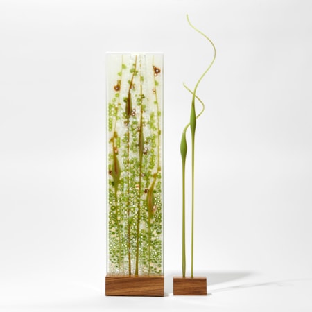 green turquoise and white flat glass panel on wooden stand with separate curling coloured rods of glass on their own stand