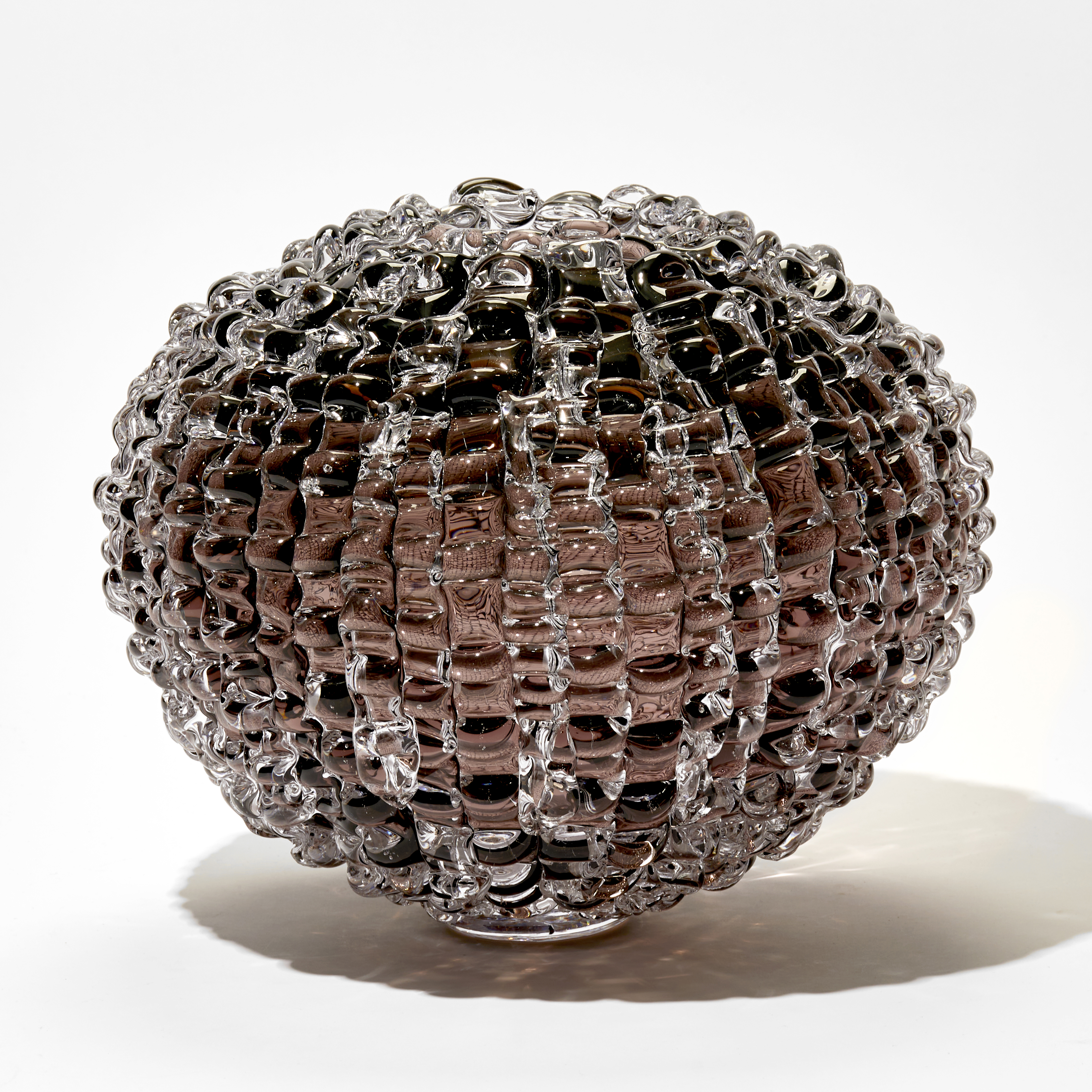 aubergine brown round vessel with undulating rippled surface hand blown from glass