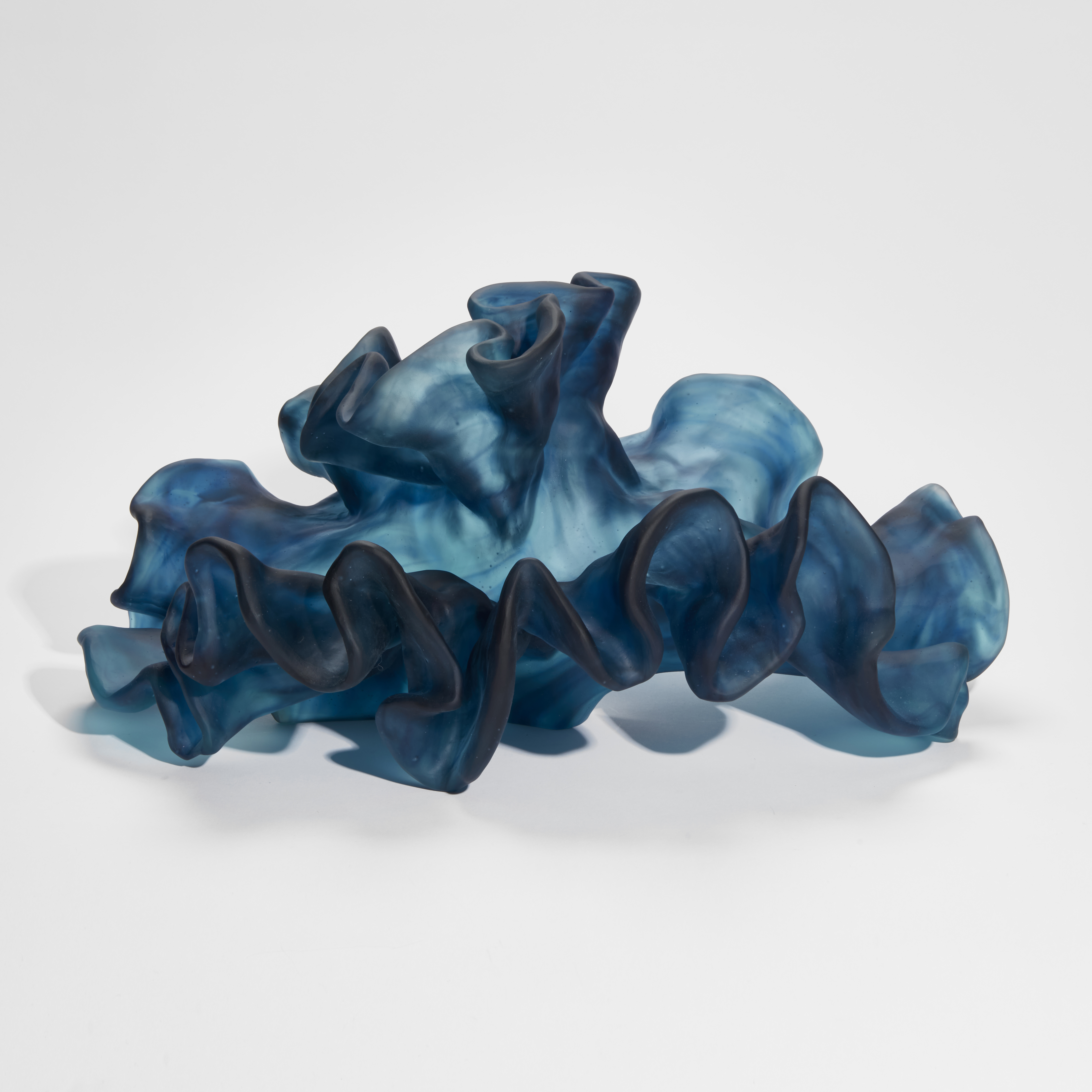 intense blue wavy and frilly sculpture hand made from cast glass