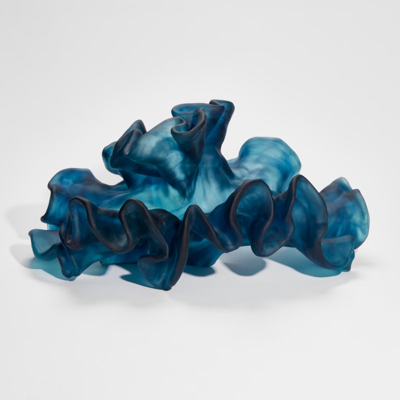 intense blue wavy and frilly sculpture hand made from cast glass