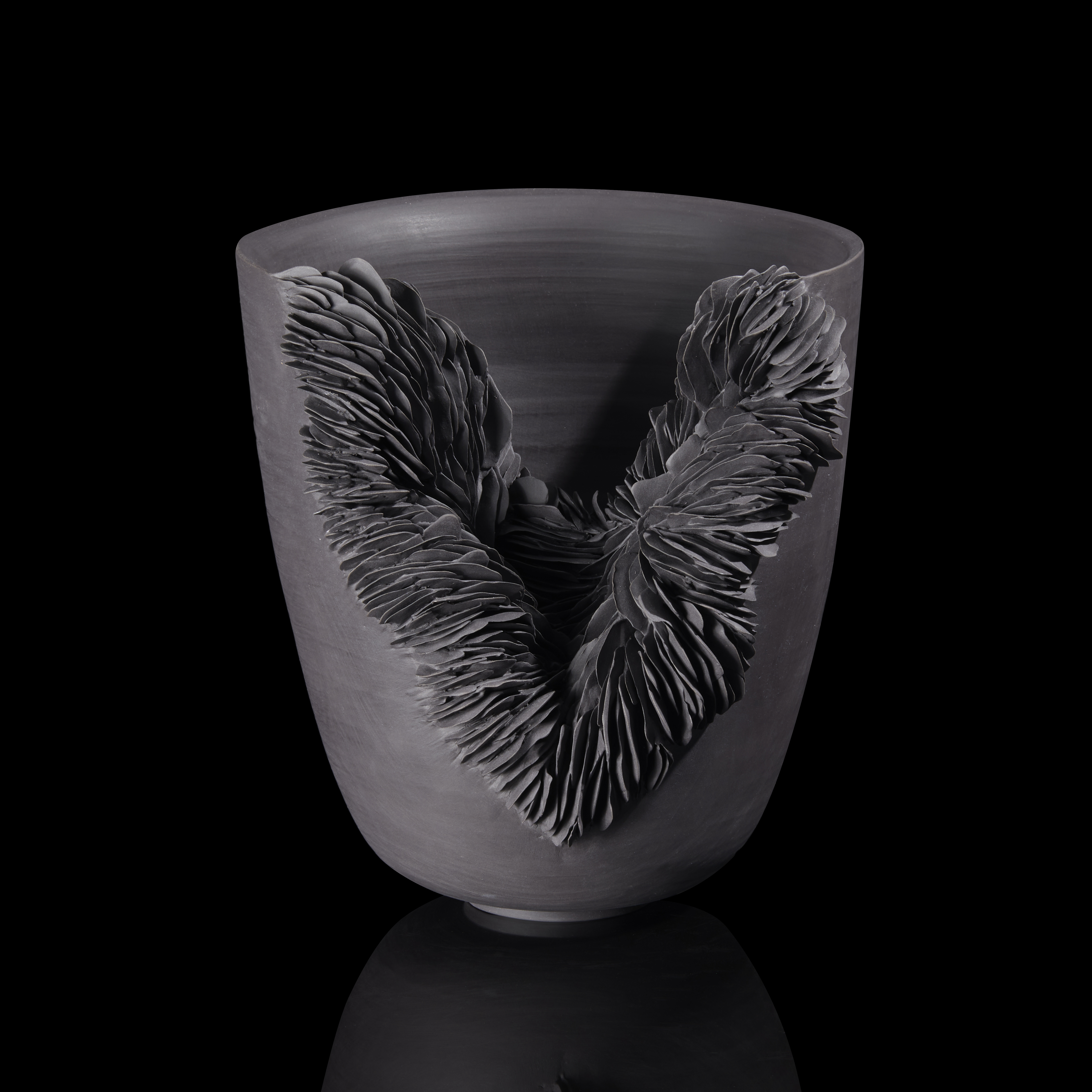 flared bowl with slashed front filled lined tiny shards handmade from black porcelain