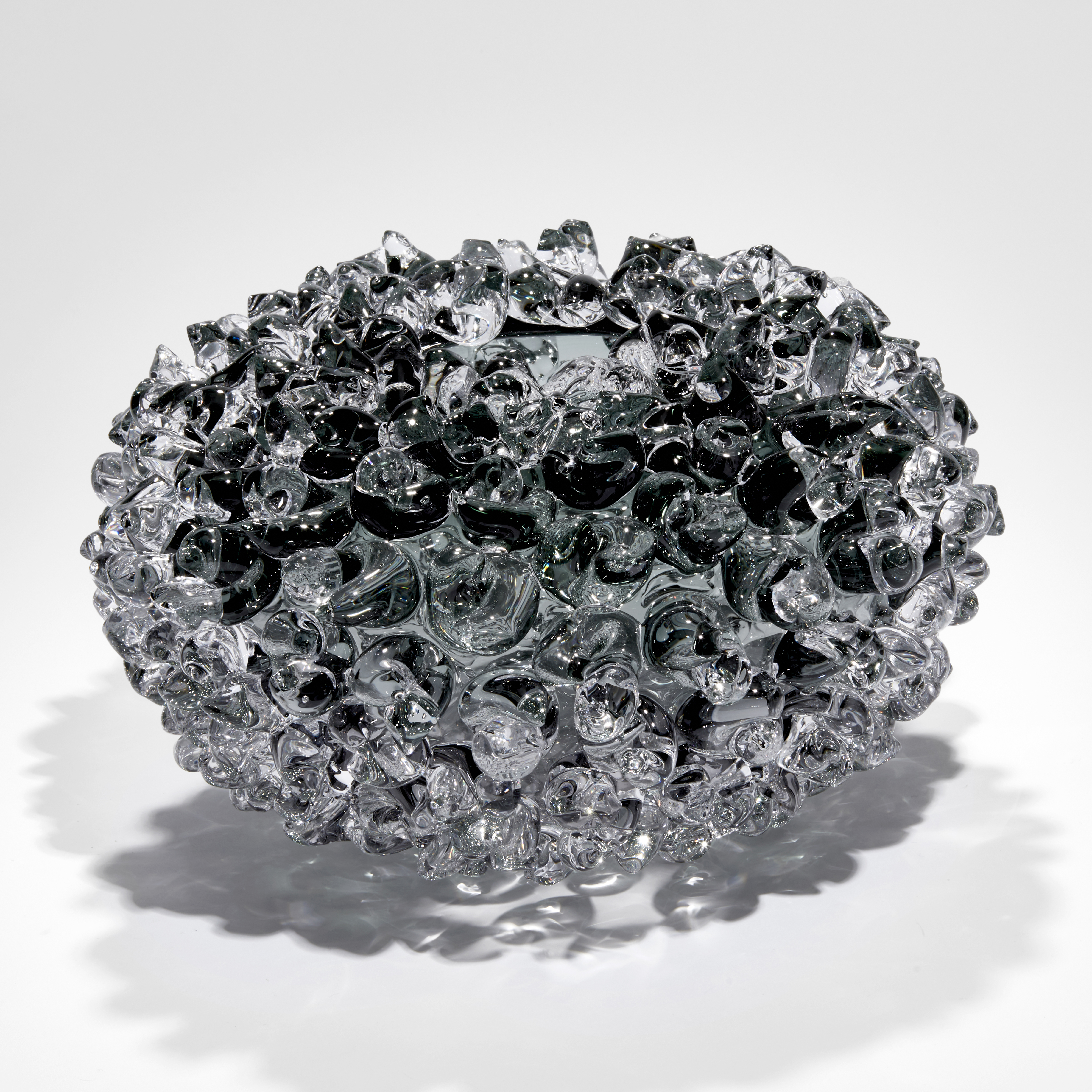 grey round stylised urchin vessel with top opening hand made from glass