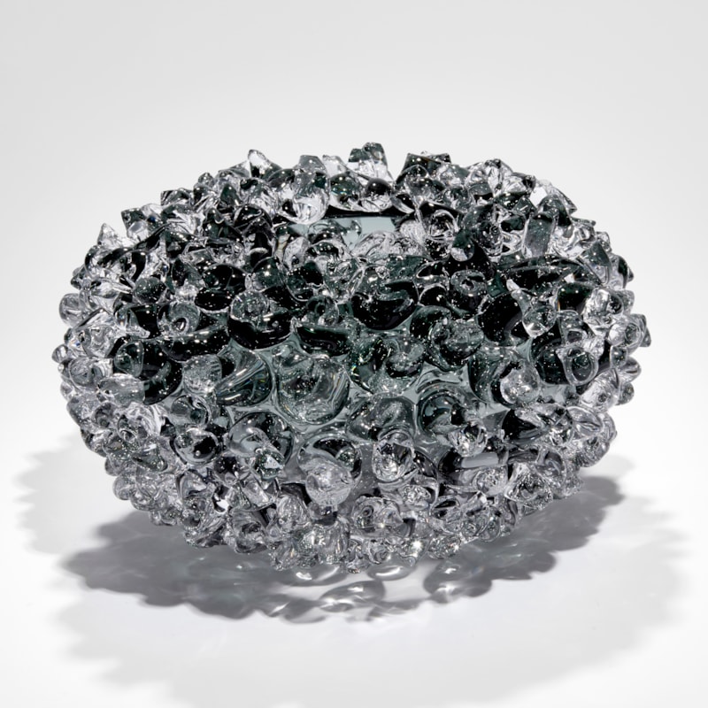 grey round stylised urchin vessel with top opening hand made from glass