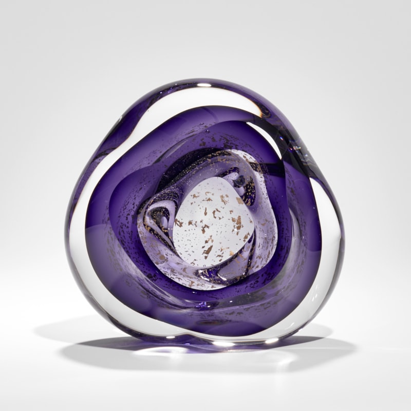 soft rounded clear and rich purple hand blown glass sculpture with floating gold leaf elements