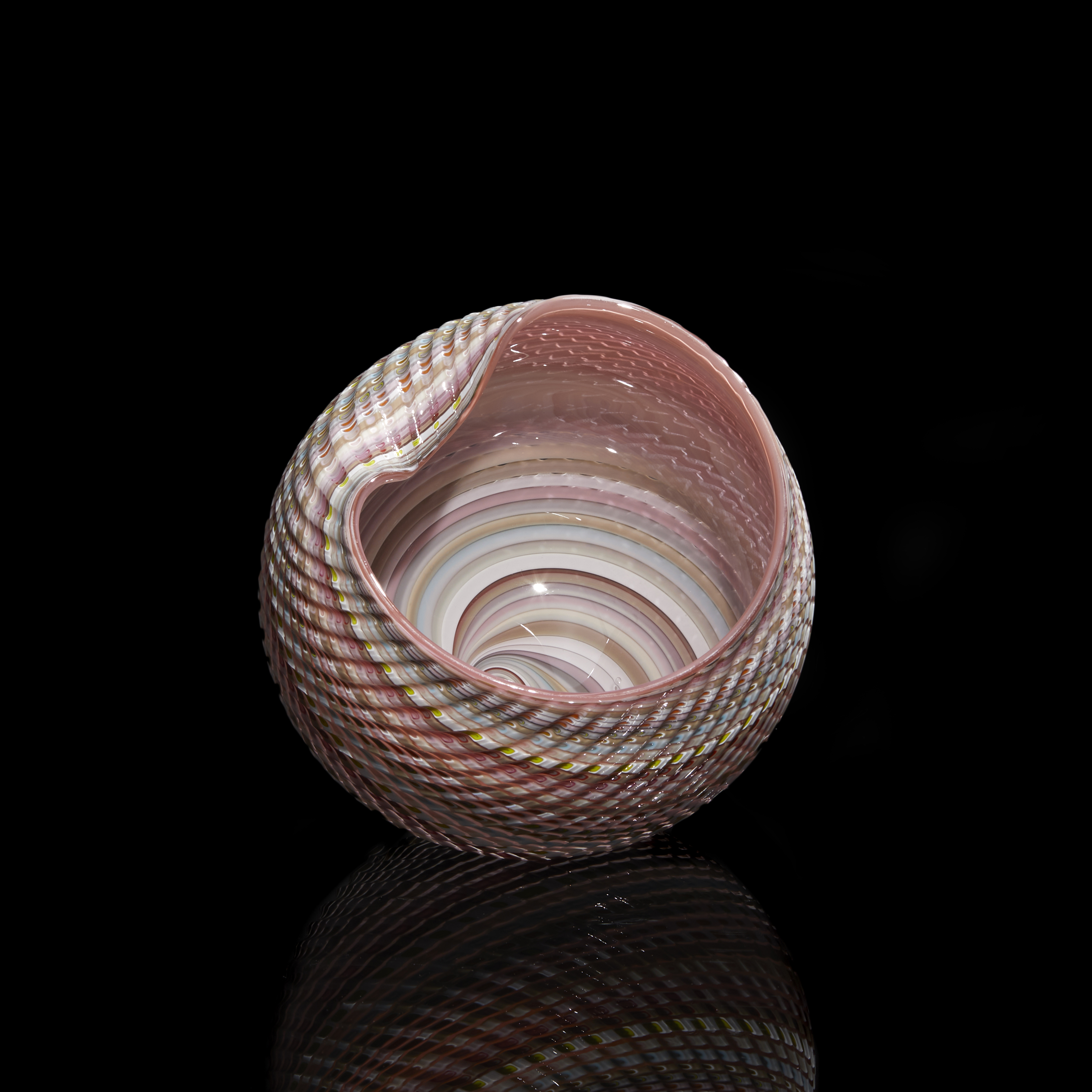 round shell sculpture in pastel colours with ridged surface and shiny interior made from glass