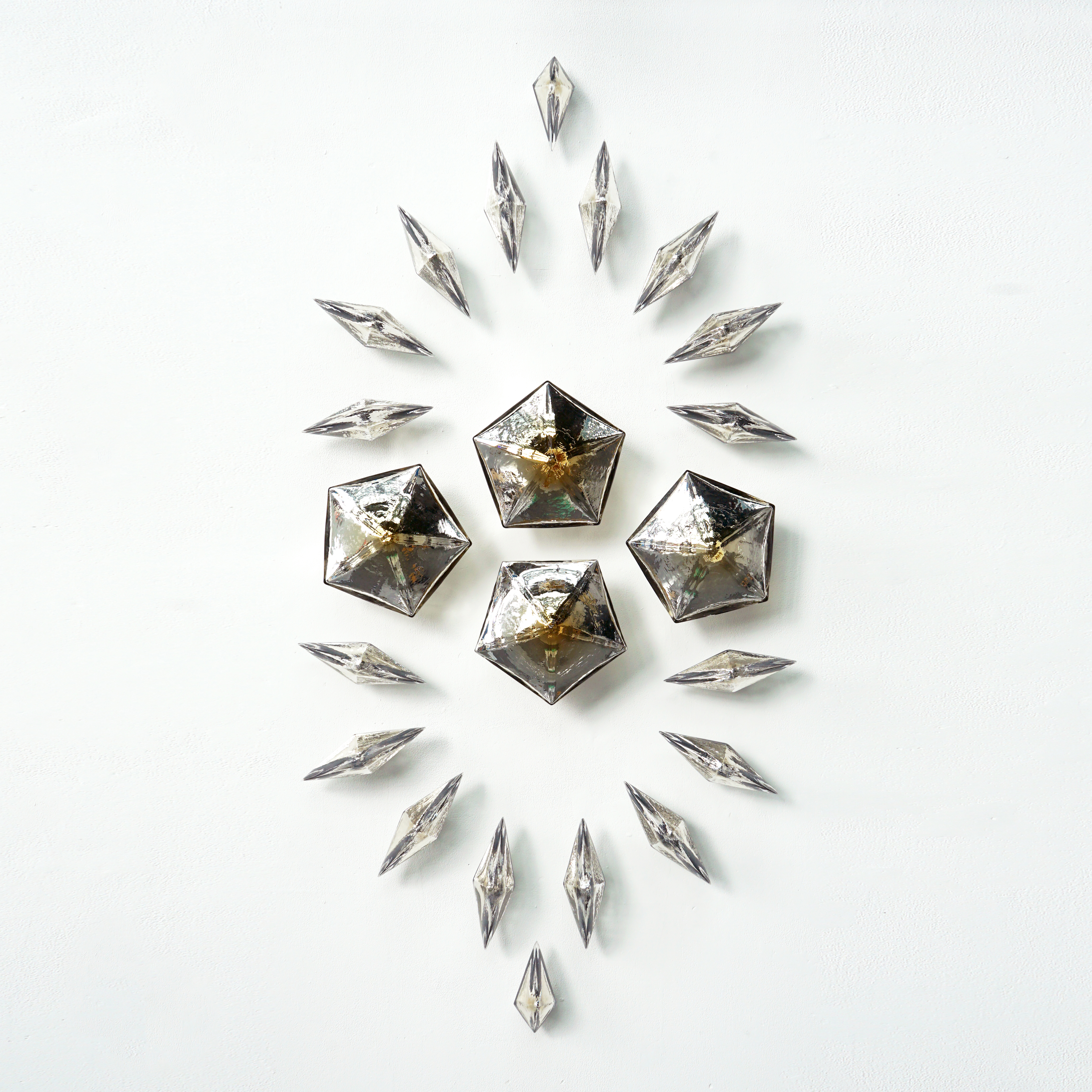 wall mounted bronze glass internally mirrored geometric shaped consisting of  pentagons and diamonds to creating a unique composition