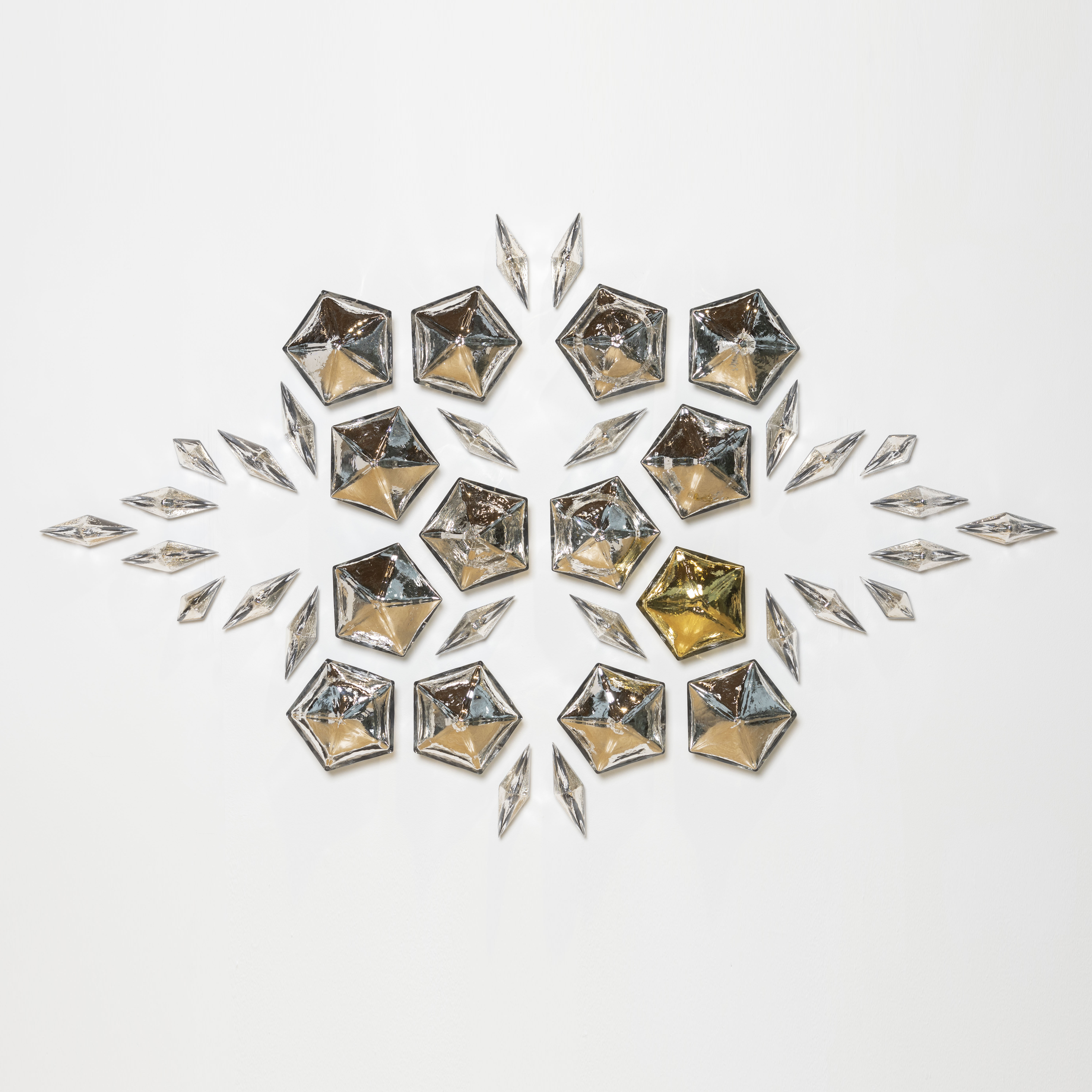 mirrors three dimensional pentagons and diamonds creating a unique pattern once hung on the wall hand made from blown glass