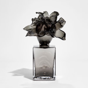 black and smokey grey box with floral explosive adornment on top handmade from glass