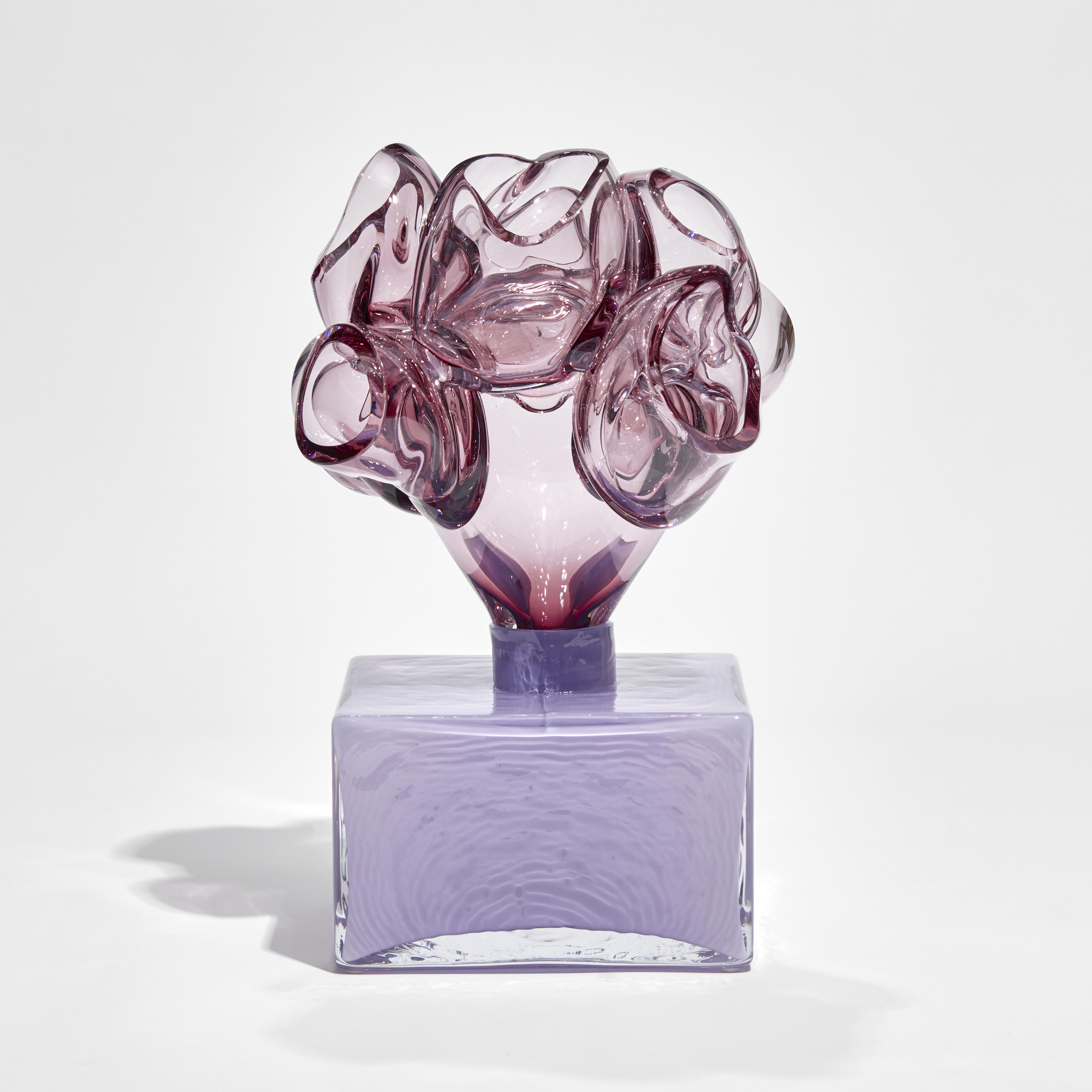 purple low box with organic floral adornment on the top hand made from glass