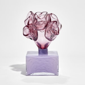 purple low box with organic floral adornment on the top hand made from glass