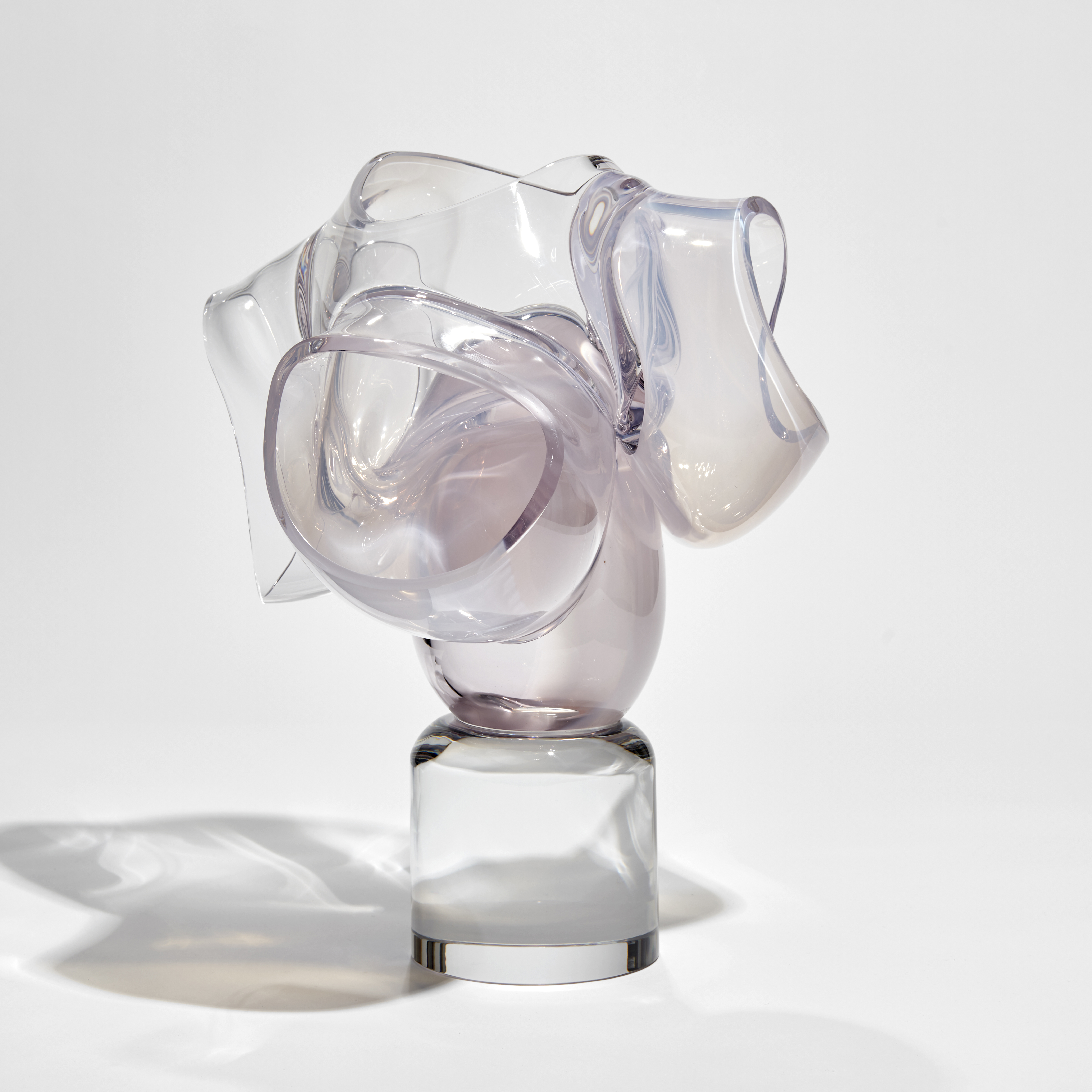 round clear base with soft pastel pink abstract floral explosion above hand made from glass