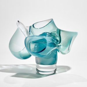 abstract sculpture of soft tubular bubbles in transparent clear and turquoise glass held aloft on a central solid trunk hand made from glass