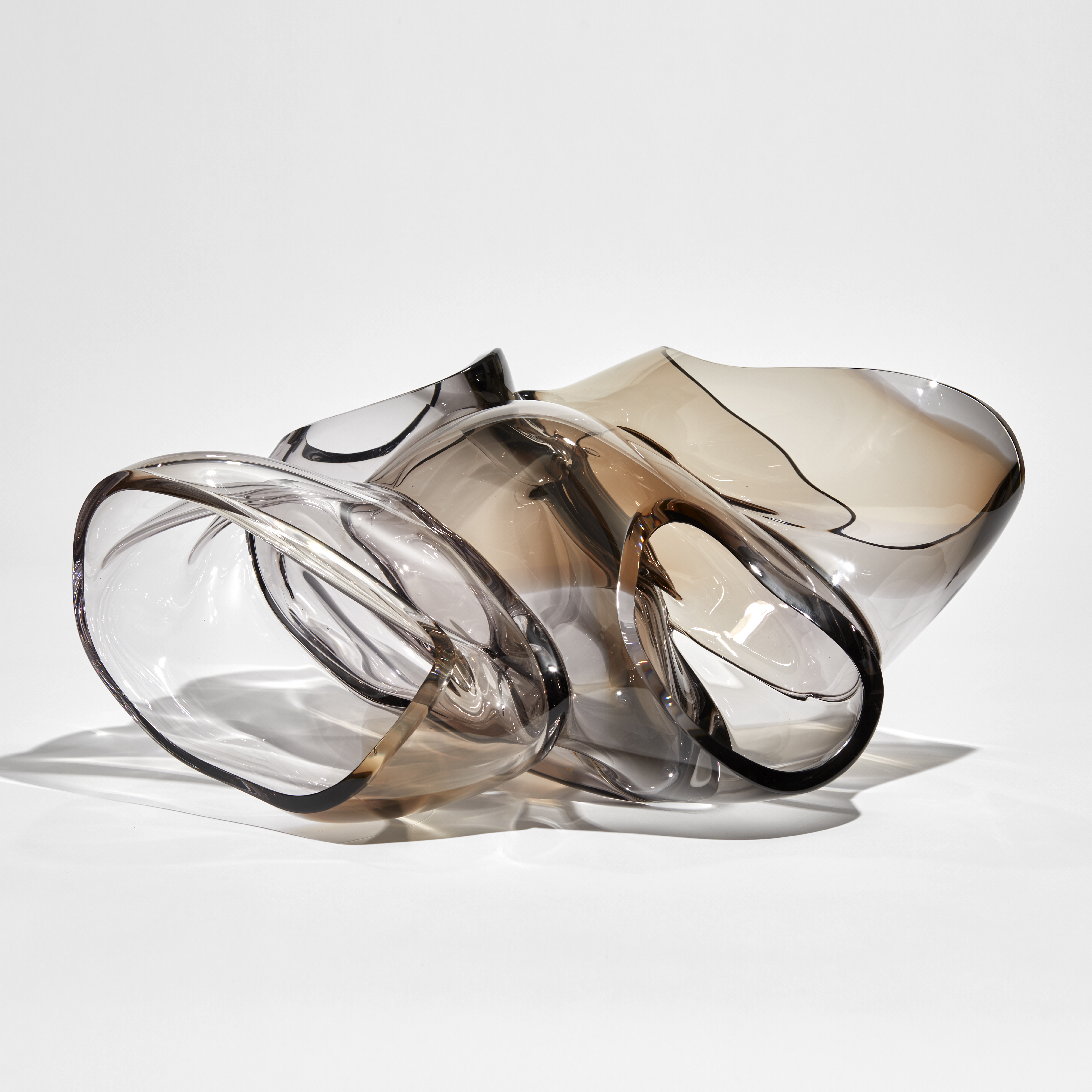 large abstract human heart aorta sculpture hand made from bronze tinted glass