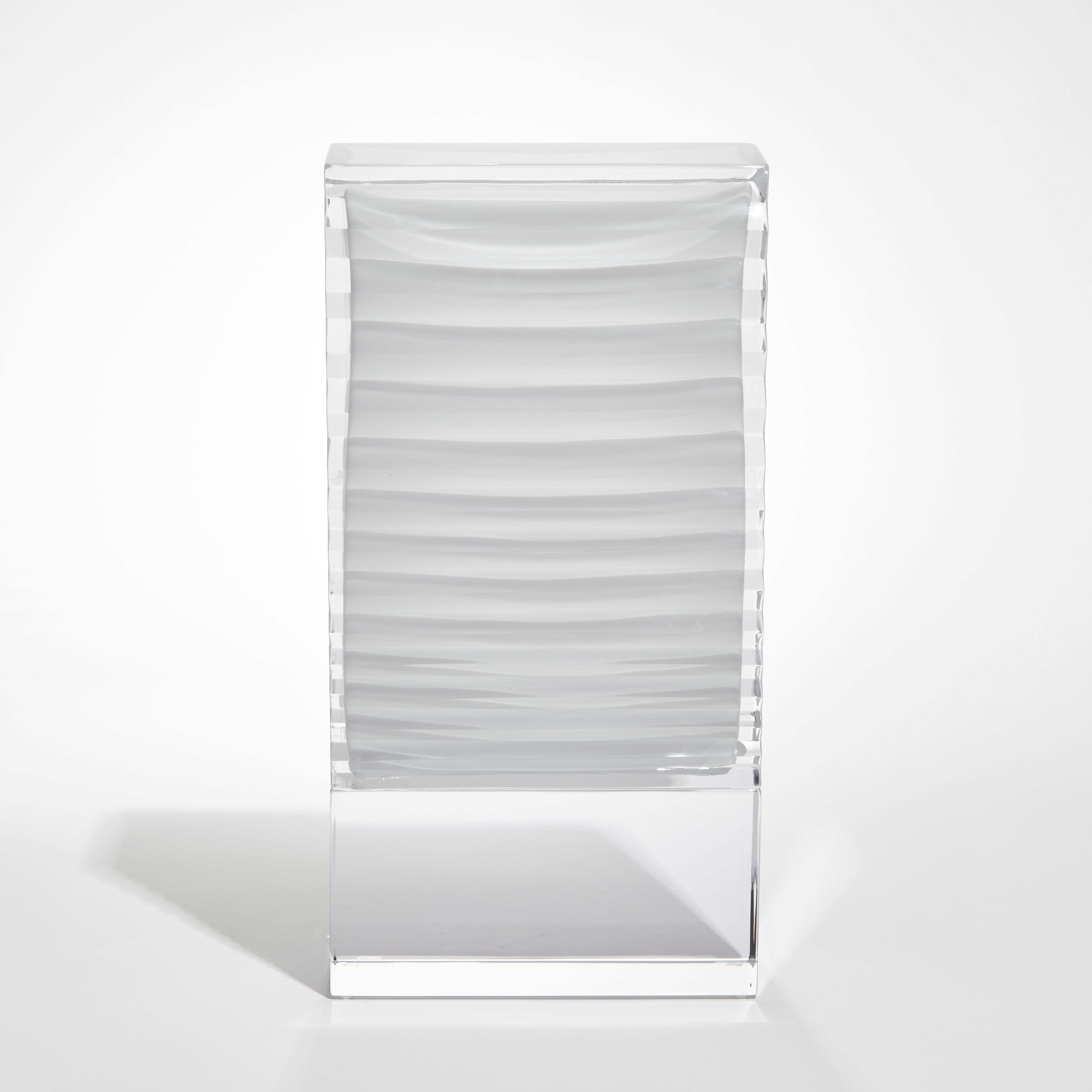 smooth surfaced standing rectangular art work with clear base and trapped internal white origami detail hand made from glass