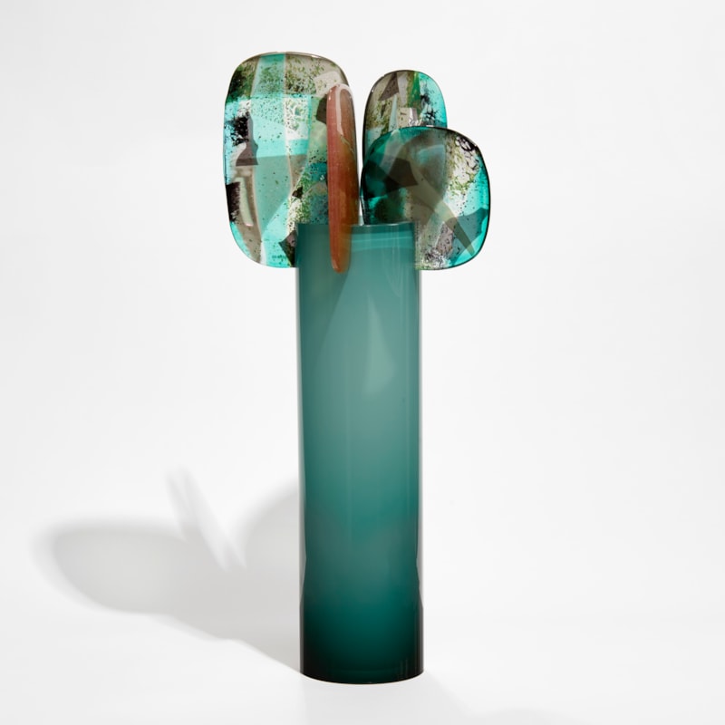 tall tube in fading from the top from light to dark green with 5 rounded finials in various colours balanced on the top hand made from glass