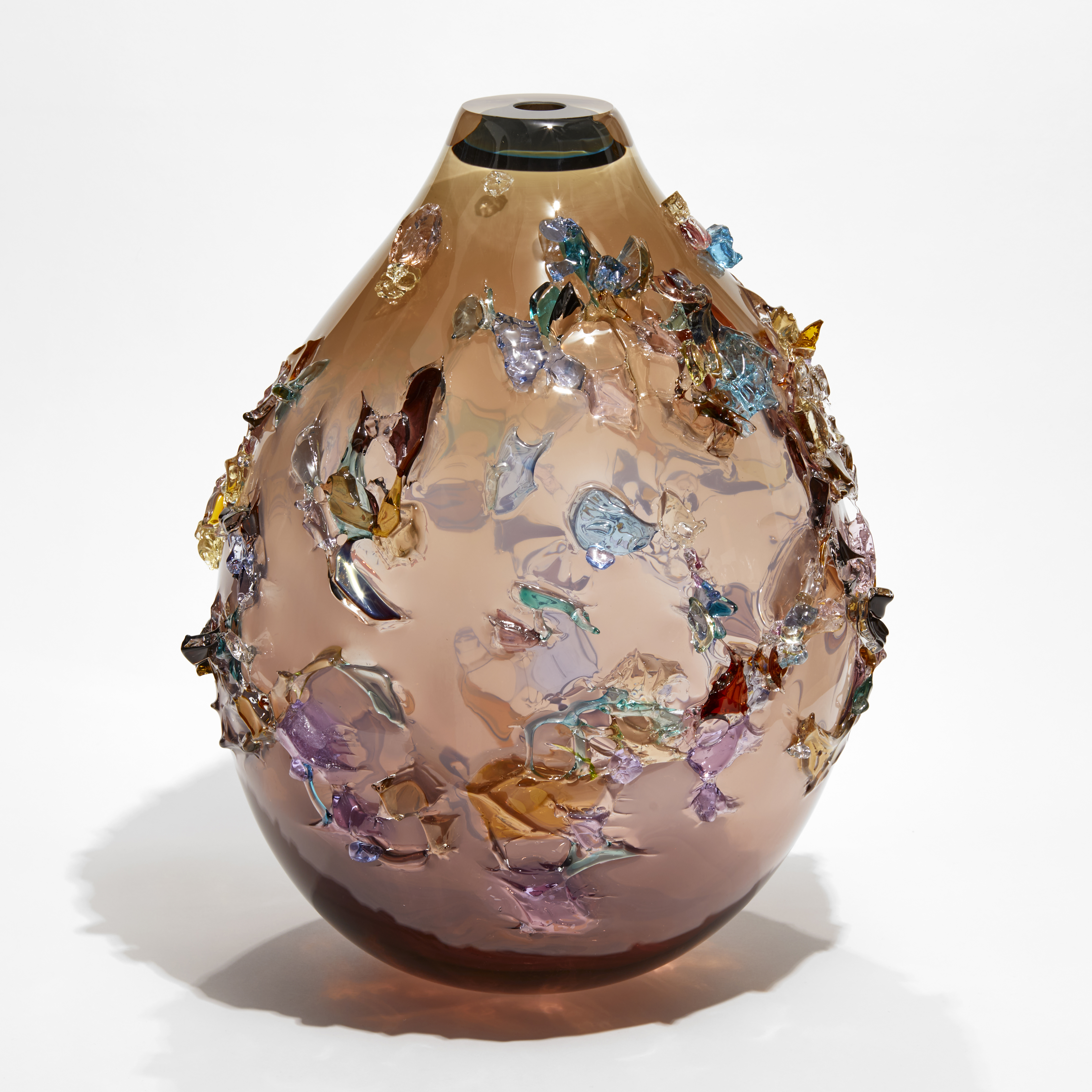 pink fading to brown rounded teardrop vessel covered in multicoloured organic shards made from blown glass
