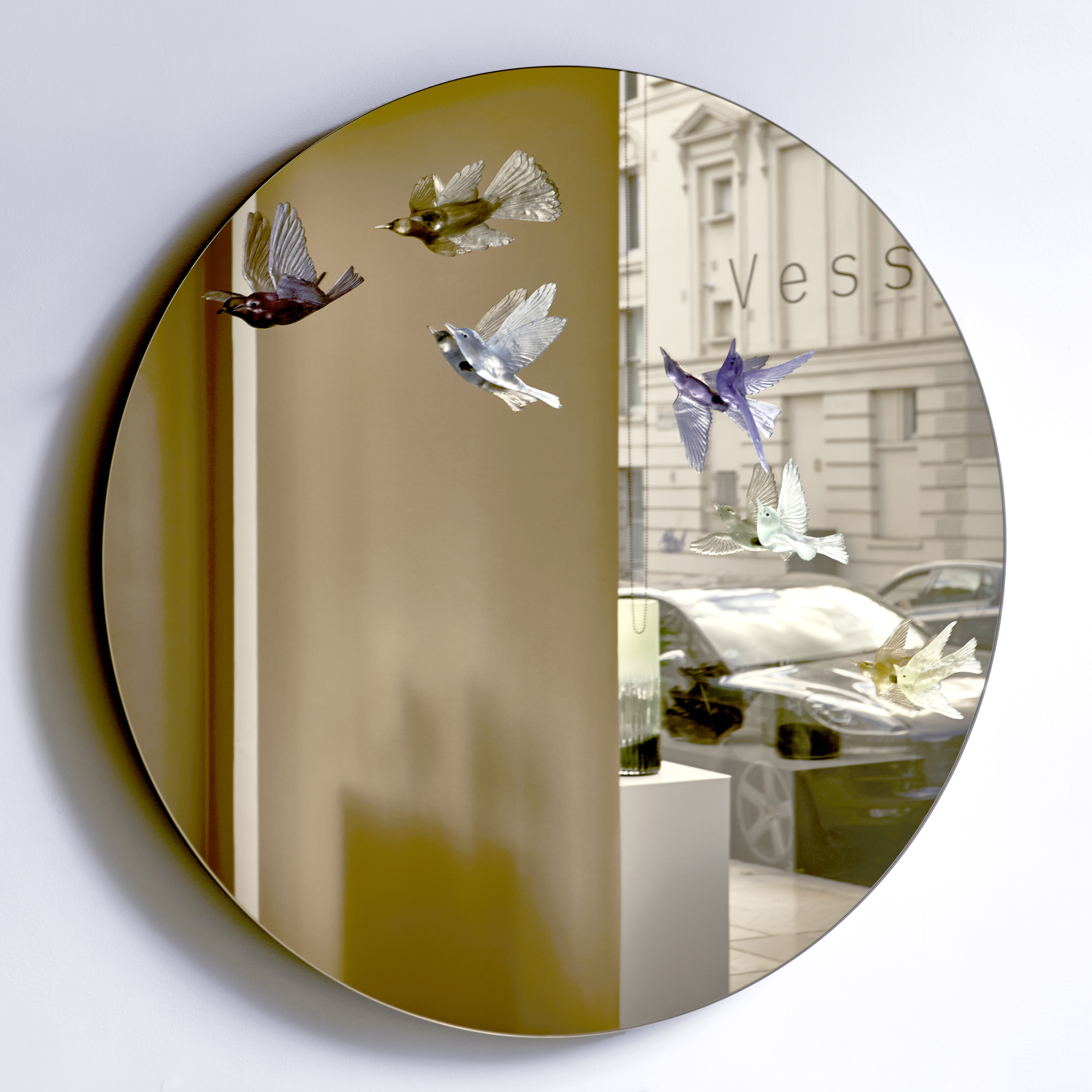 round blue art glass mirror with bird sculptures