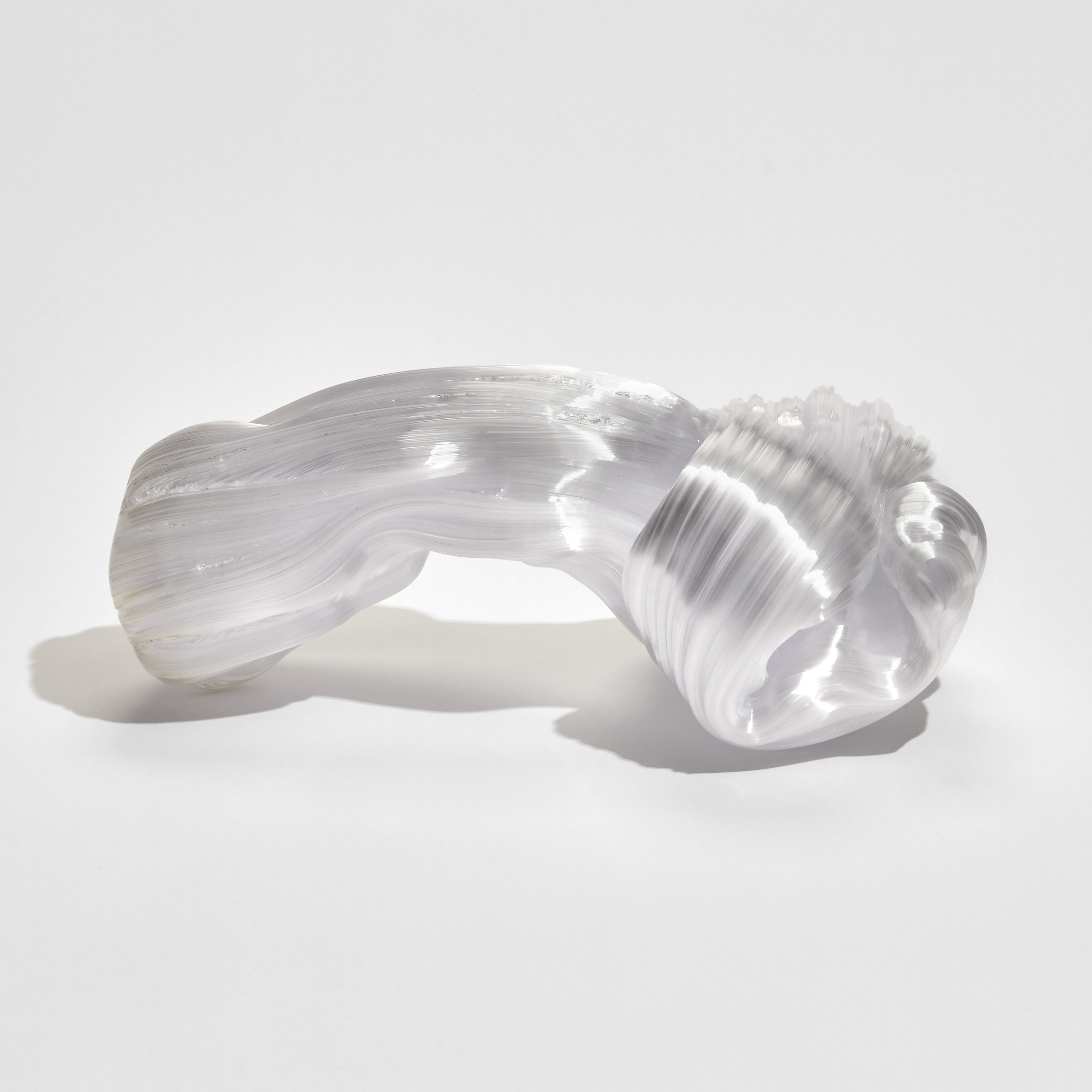 chunky bowed white glass sculpture with the appearance as if made from pulled sugar cane with a knot at one end