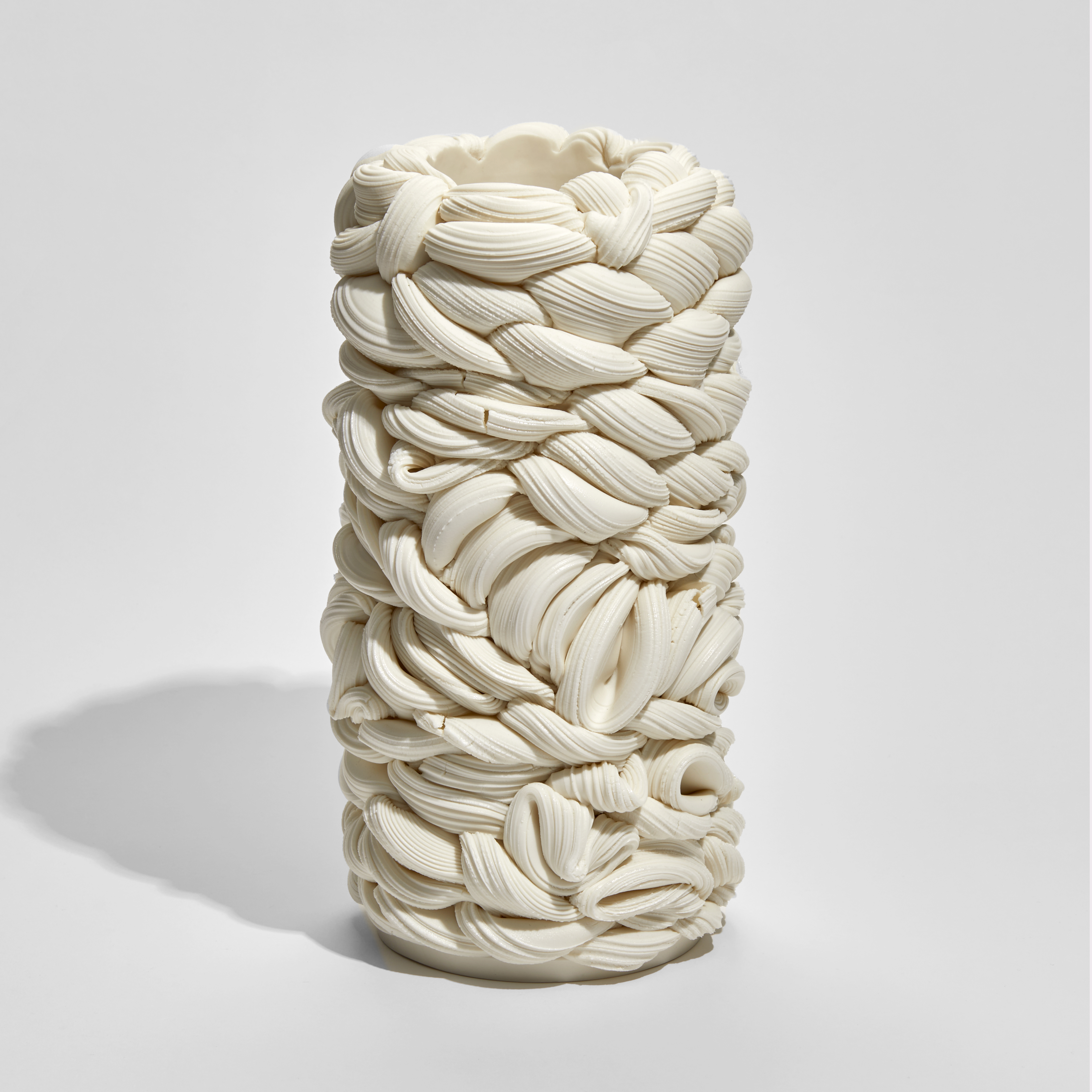 white interwoven white column vessel of folding forms hand made from parian porcelain