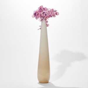 tall and thin simplified tree sculpture with smooth beige and cream trunk with candy pop rounded lollipop leaves clustered at the top hand made from glass