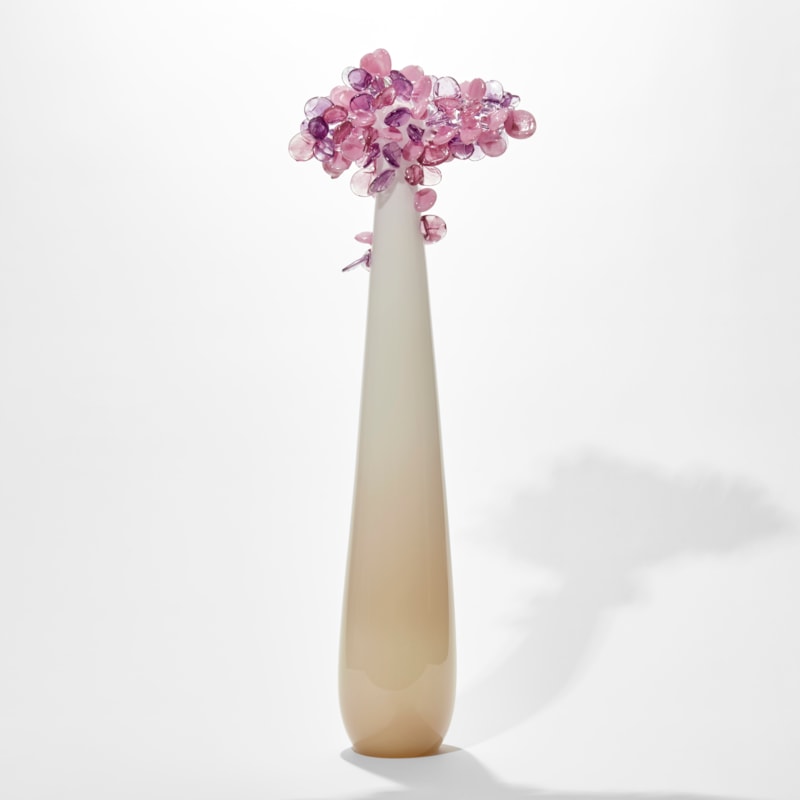 tall and thin simplified tree sculpture with smooth beige and cream trunk with candy pop rounded lollipop leaves clustered at the top hand made from glass